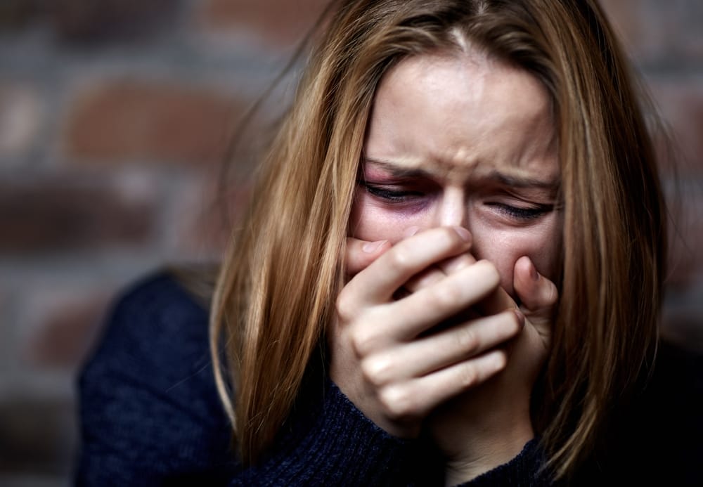 Emotionally victimized woman crying.