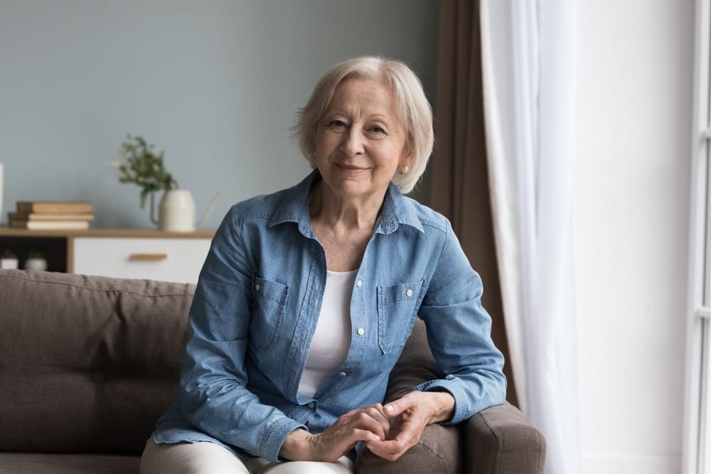 Calm older woman smiling.
