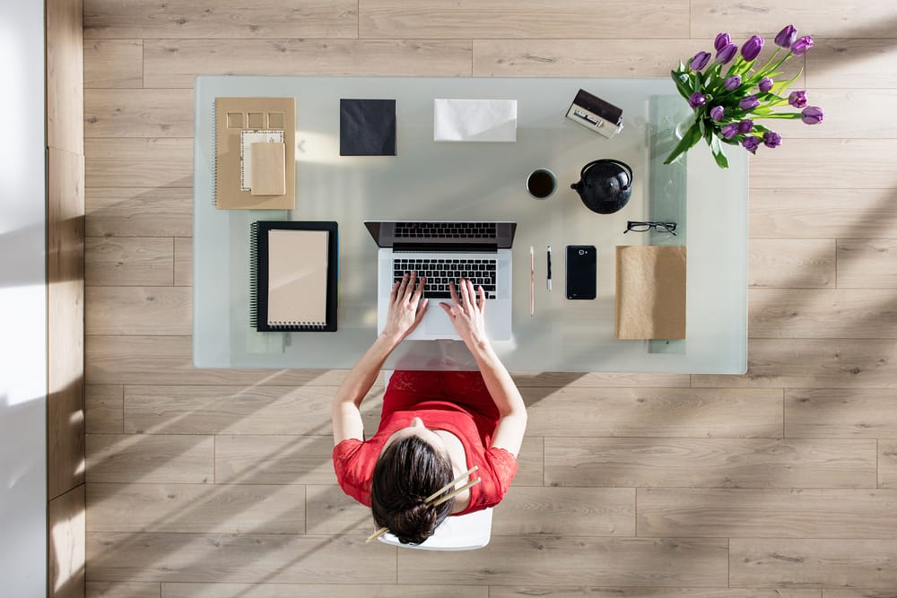 Top view of a woman at her desk.