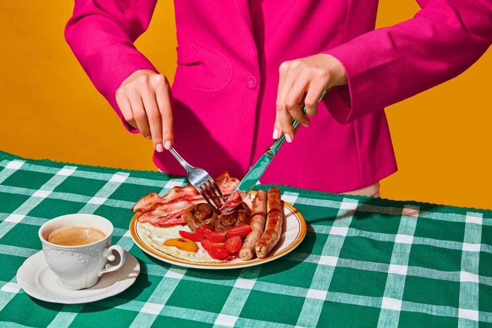 Woman eating a large meal.