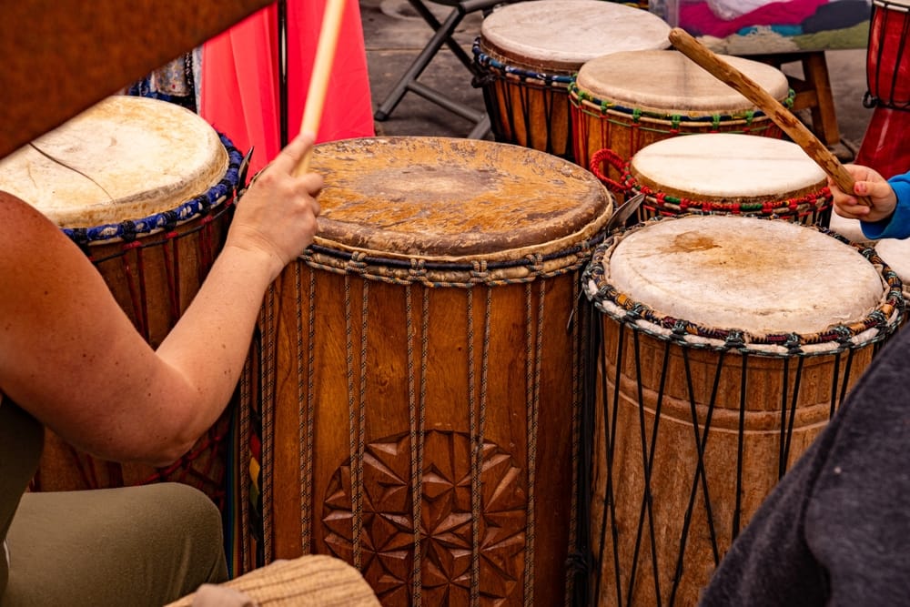 Woman and child playing the drums.
