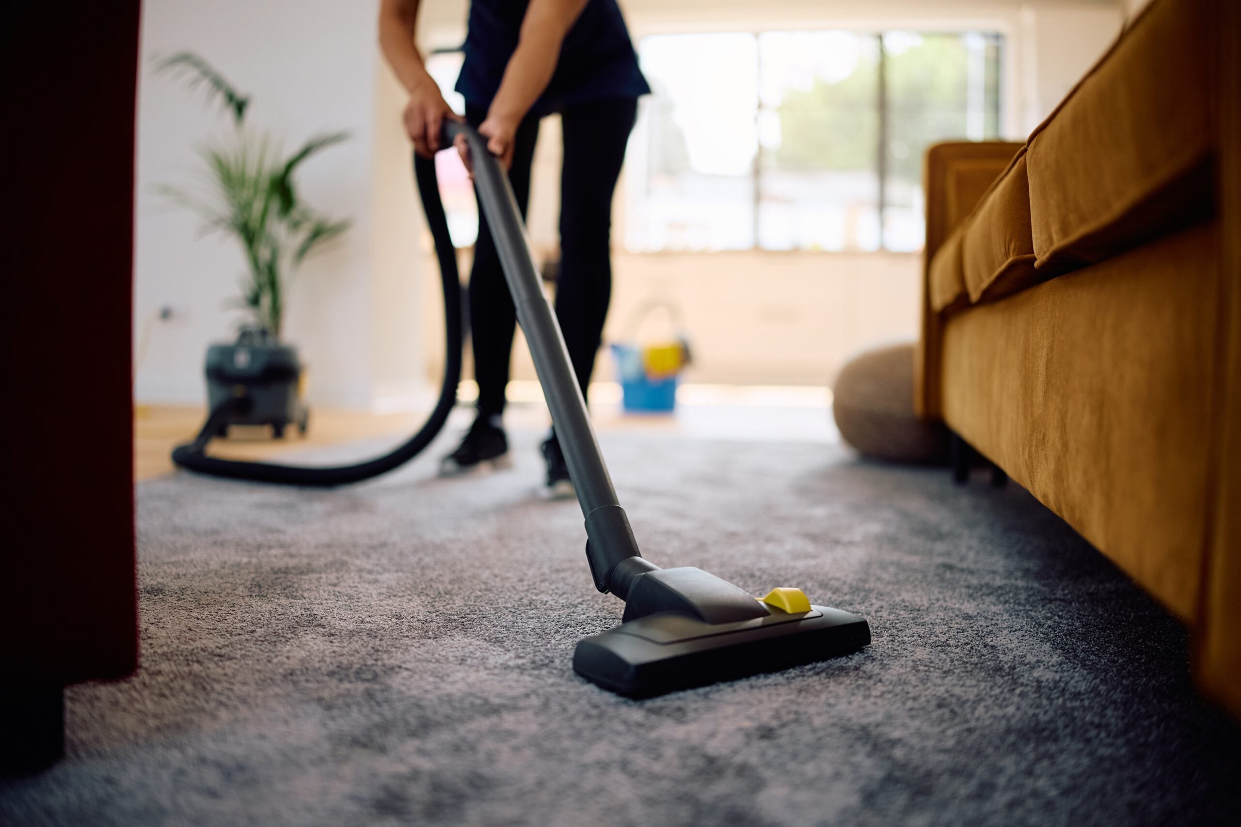 A woman vacuuming her living room.