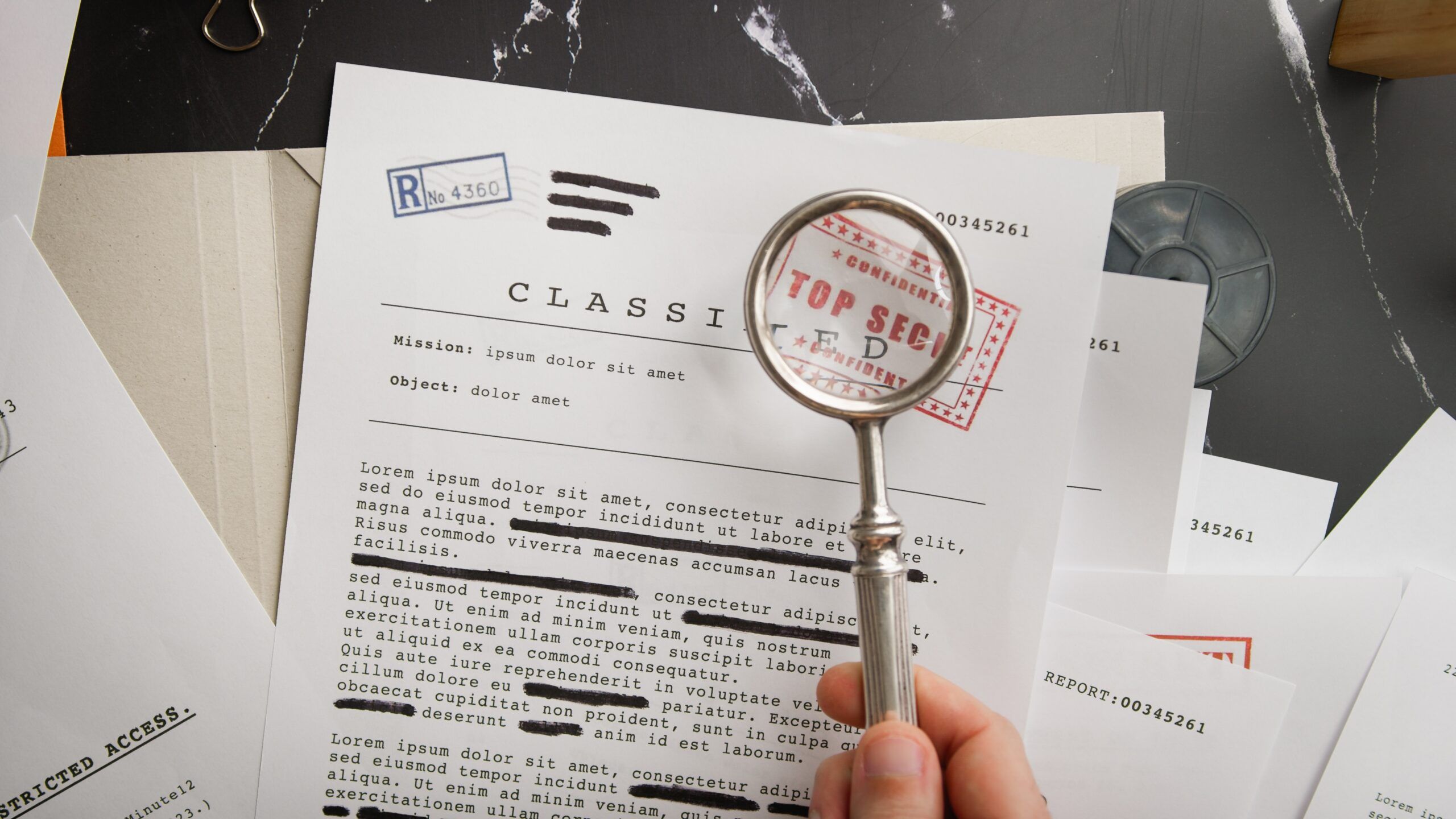 Classified papers and a magnifying glass.