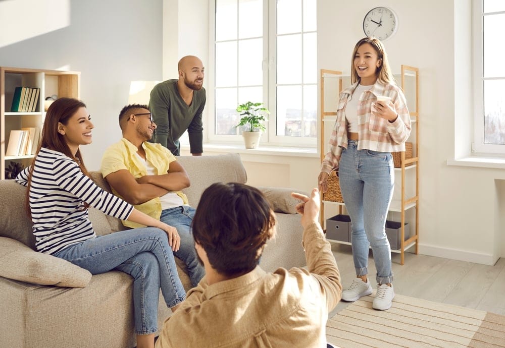 A group of happy friends talking and having fun in one of their living room