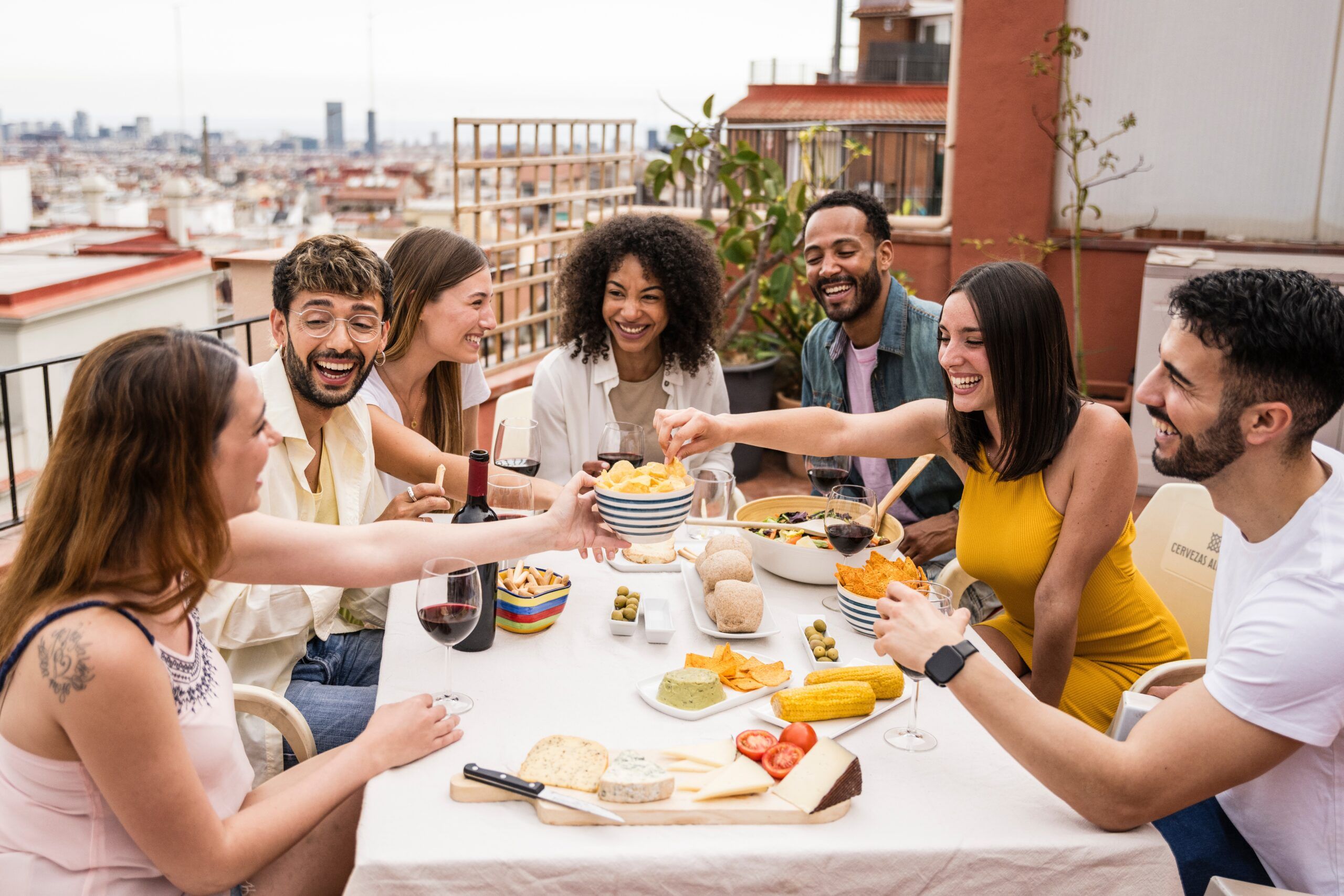 Friends enjoying one another's company at an outdoor dinner party.