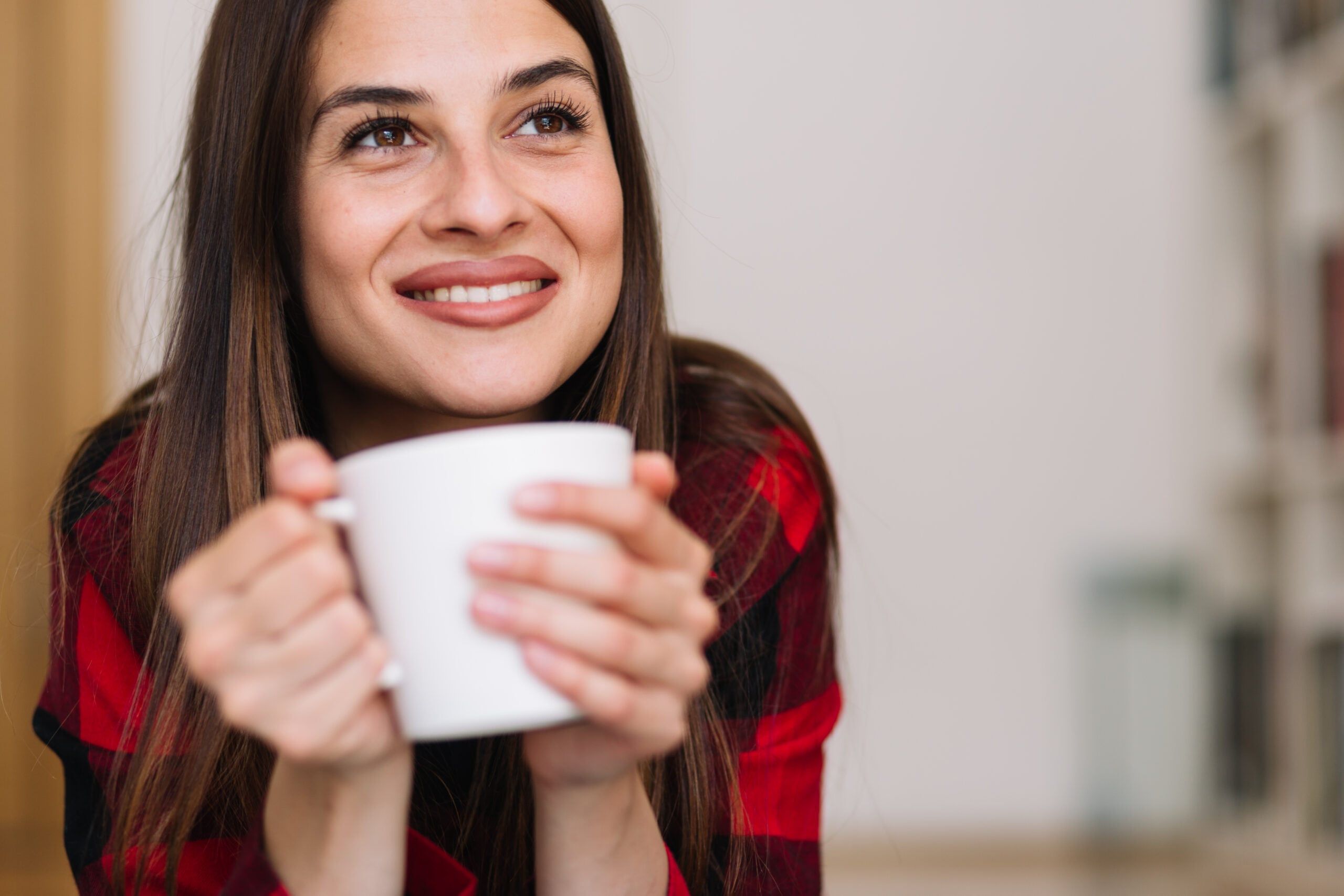 A woman enjoying time alone with a cup of tea.