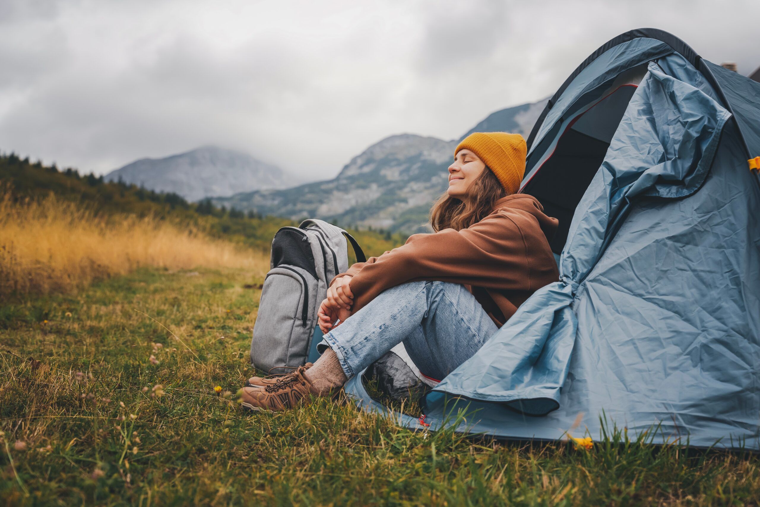 Woman camping alone in a tent.