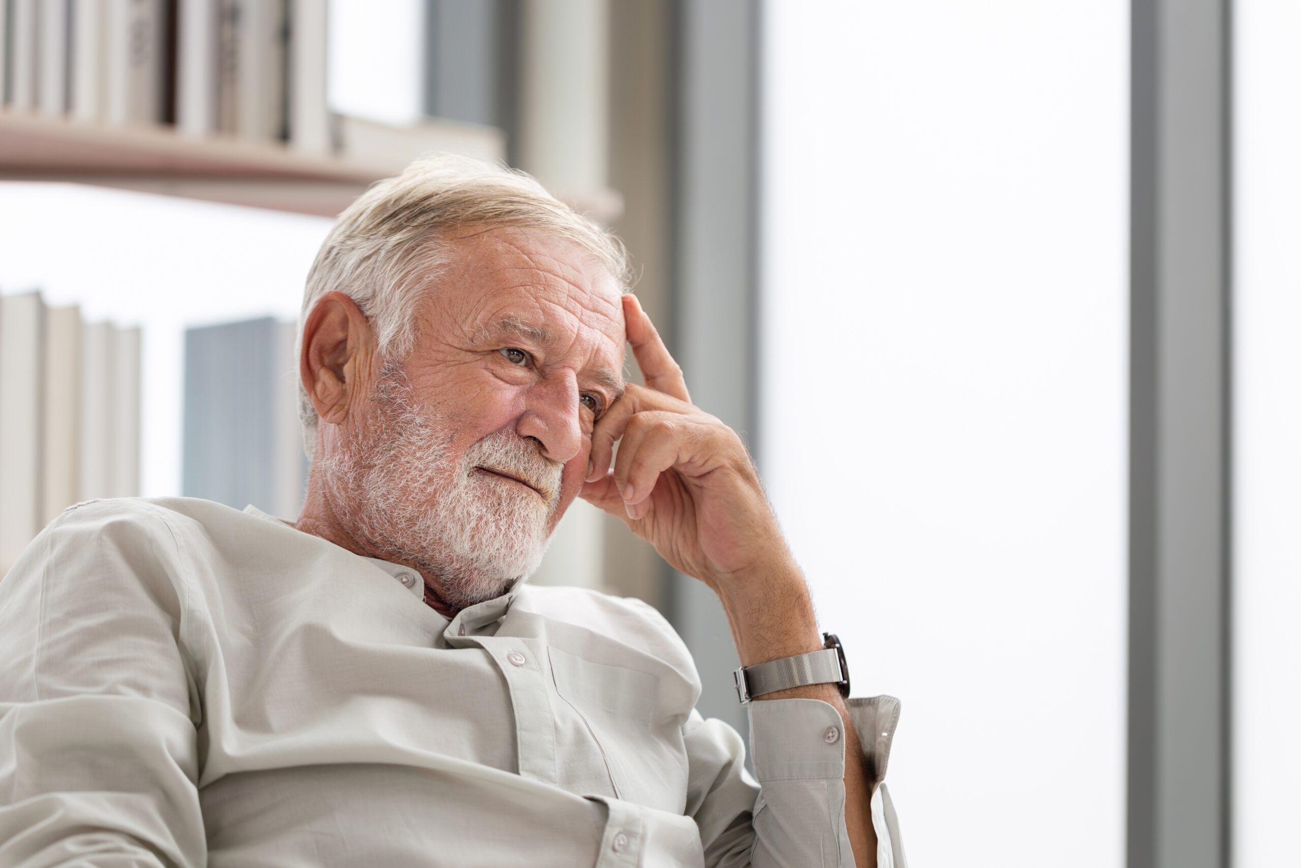 Older kind man siting in his home office.