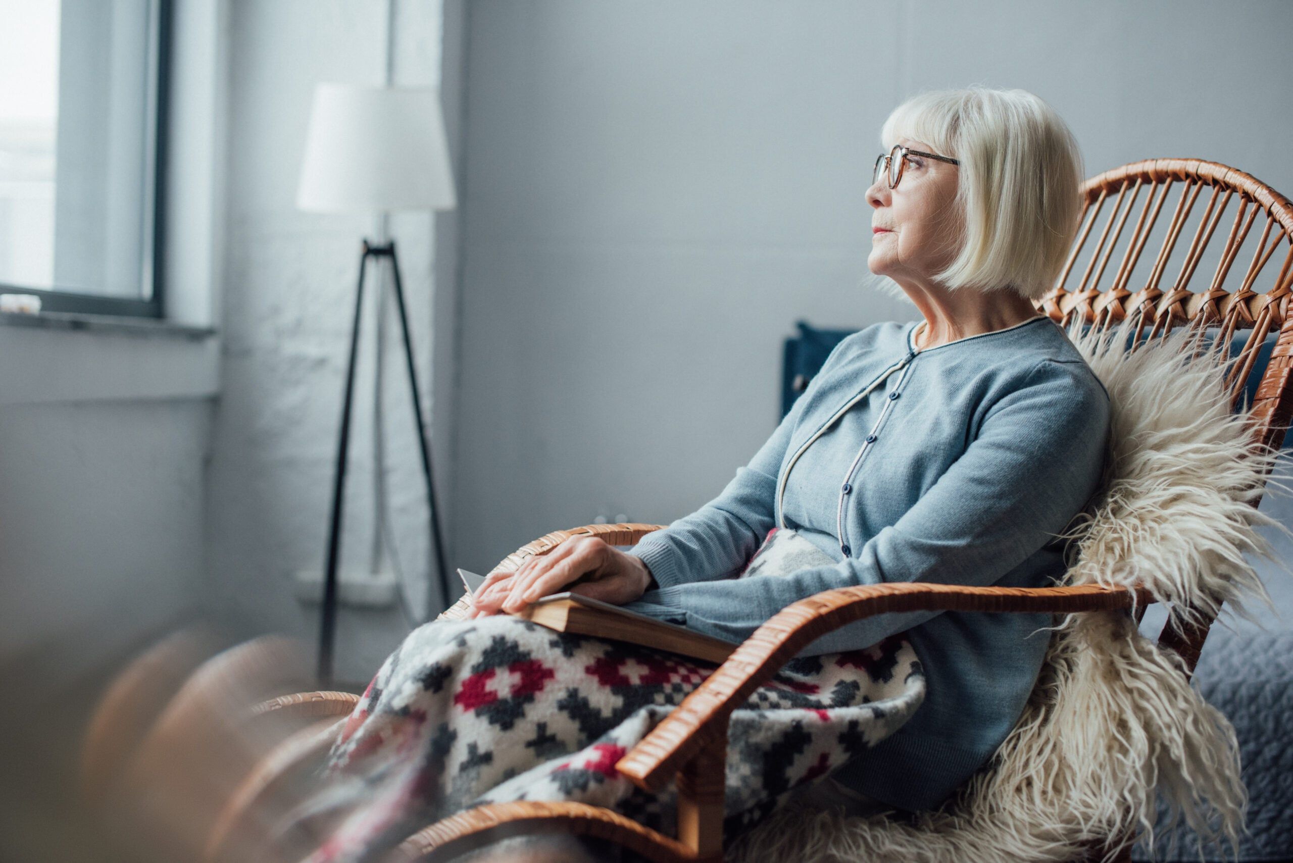An isolated senior woman sitting alone.