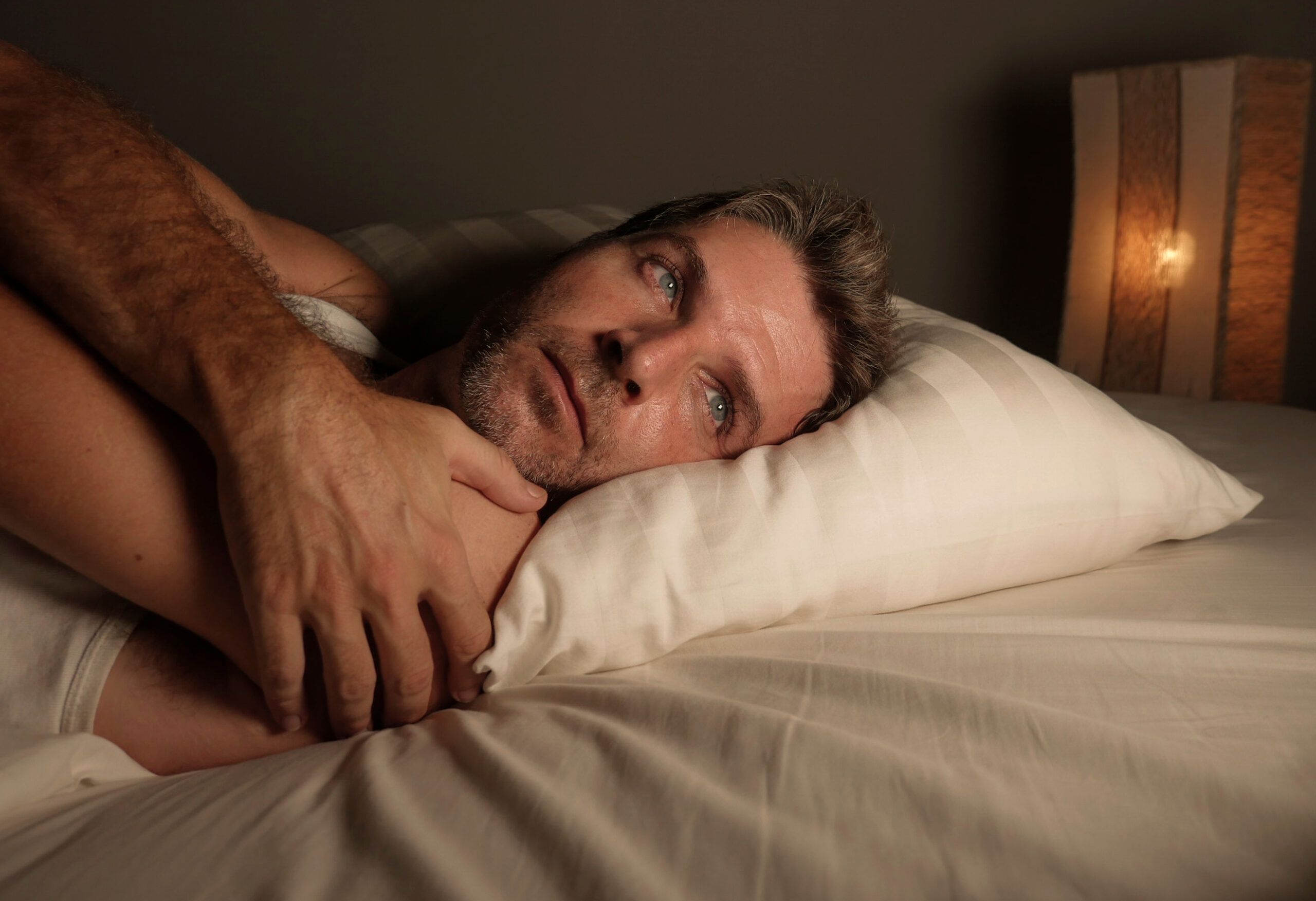 A man having just woken up from a nightmare.