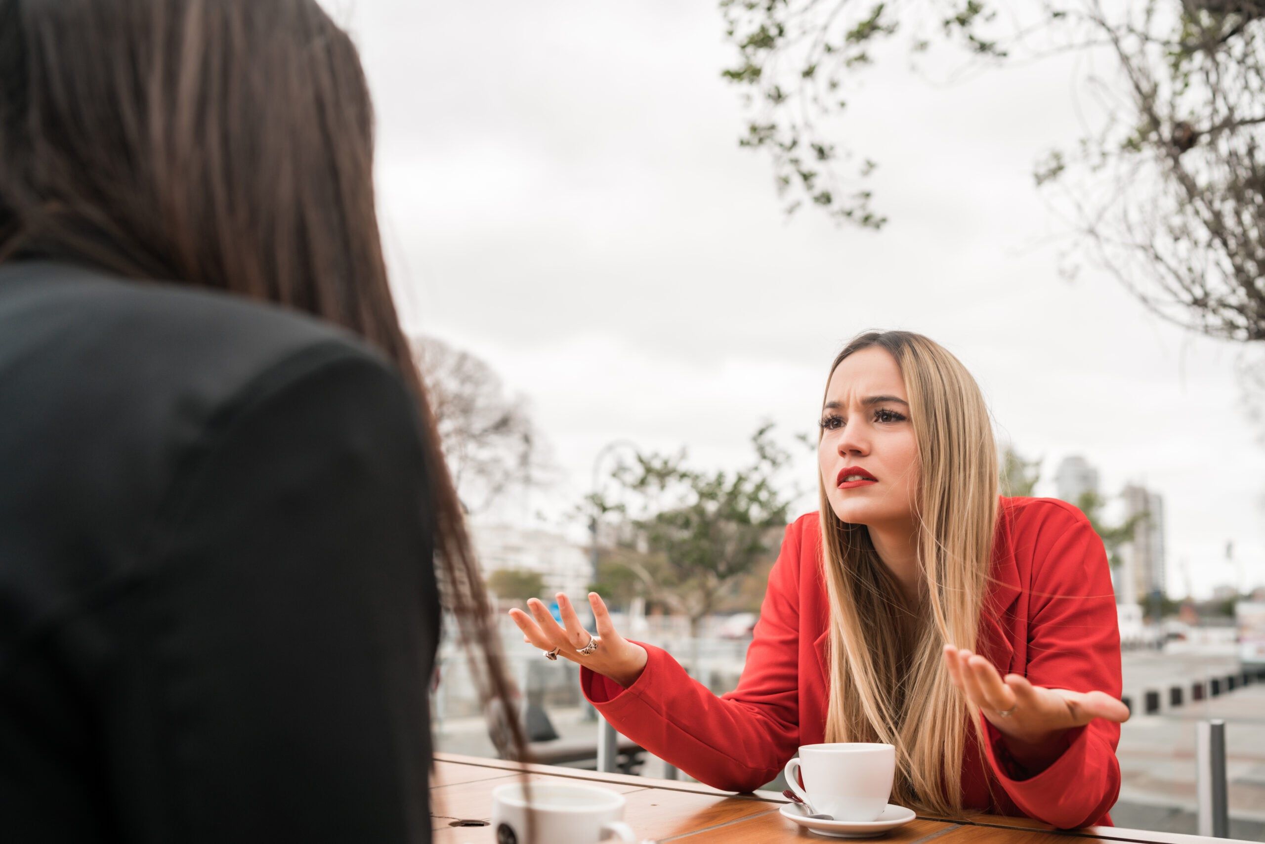 A woman sitting through another one-sided conversation with her friend.