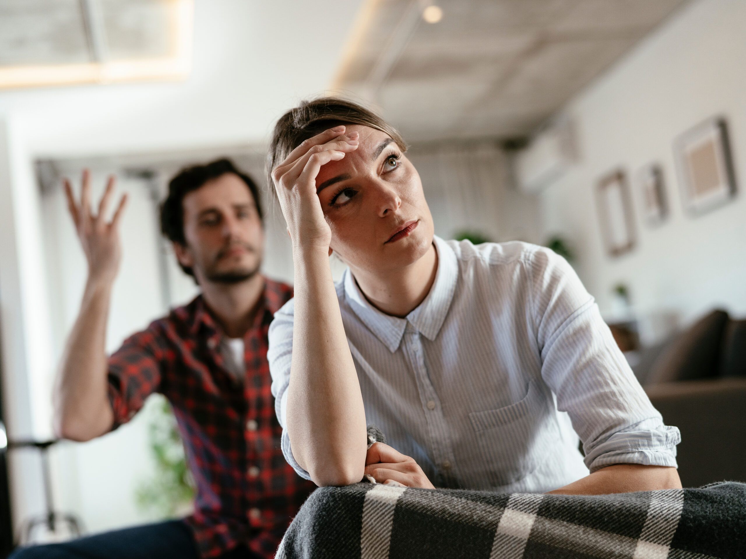 A husband and wife in an argument at home.