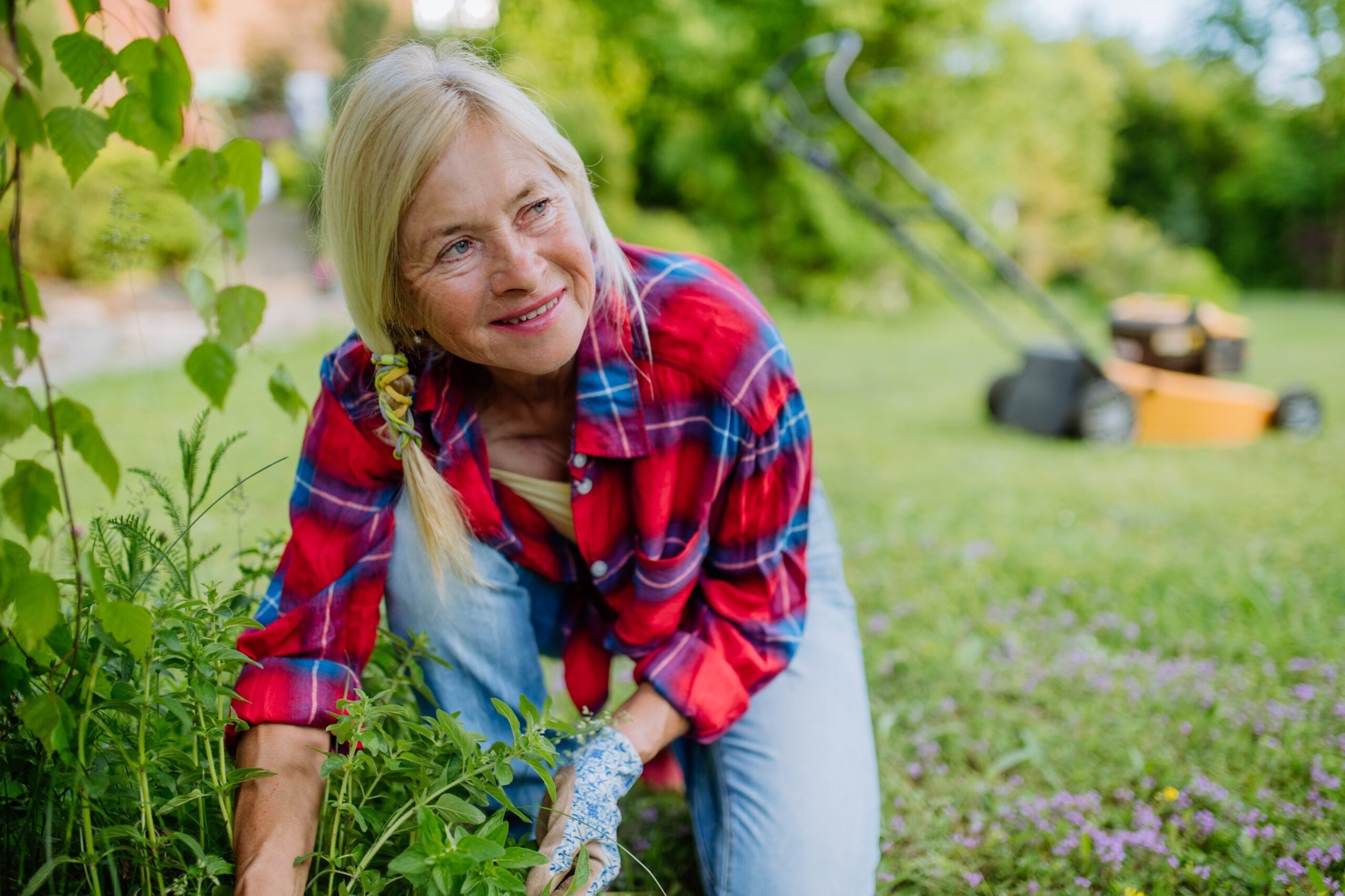 A patient midlife woman spending time in her garden.