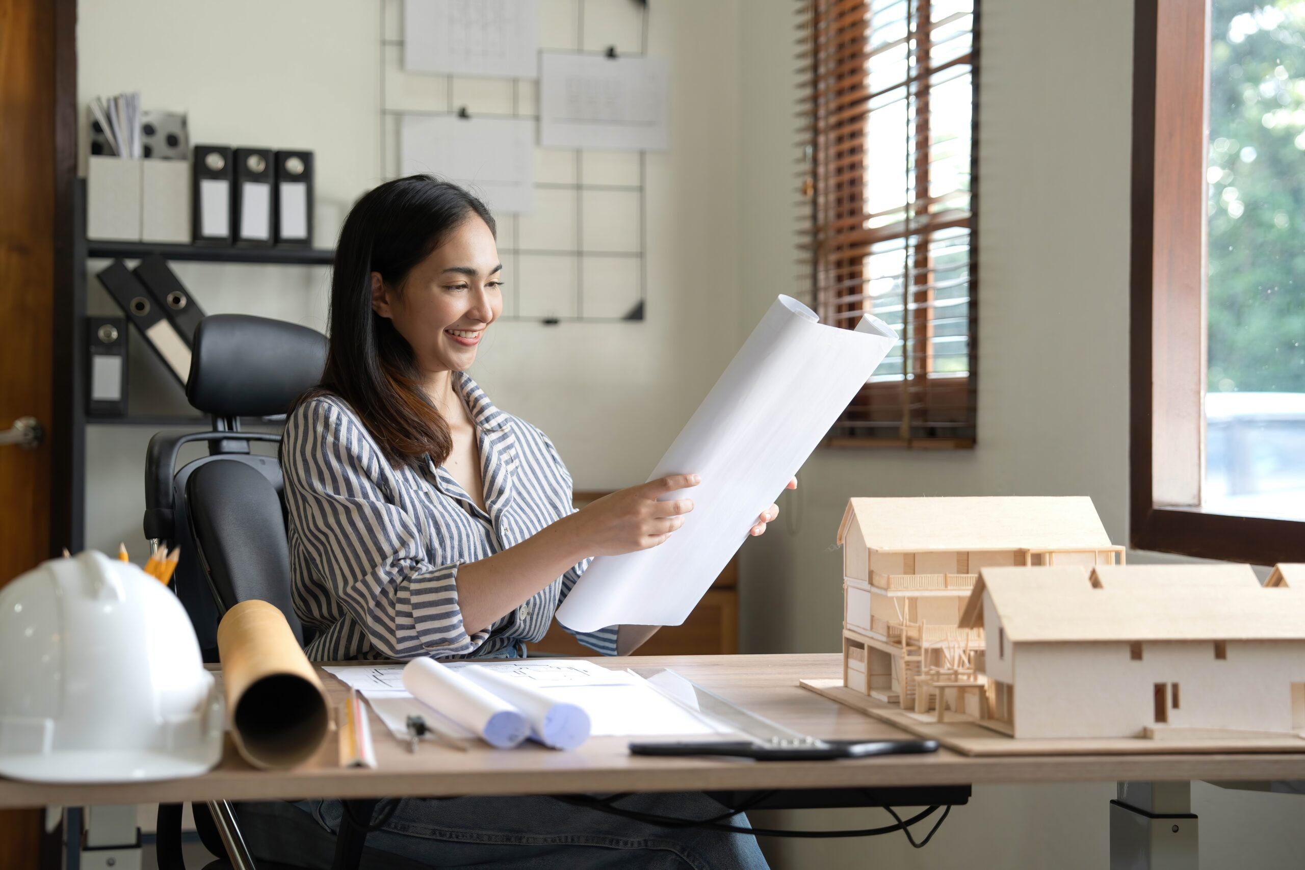 A female architect with very high standards finishing an important project.