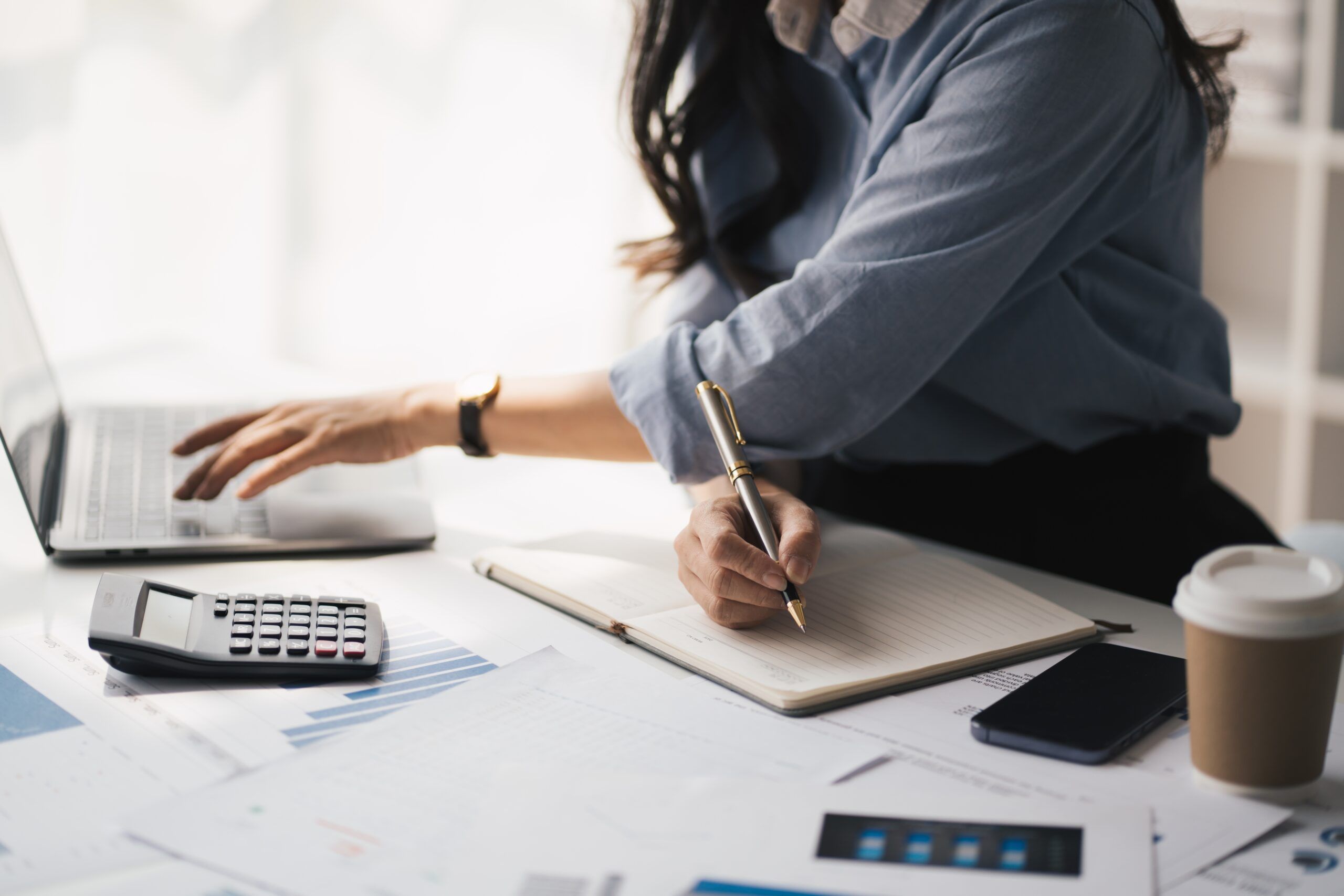 A busy businesswoman at work at her desk.