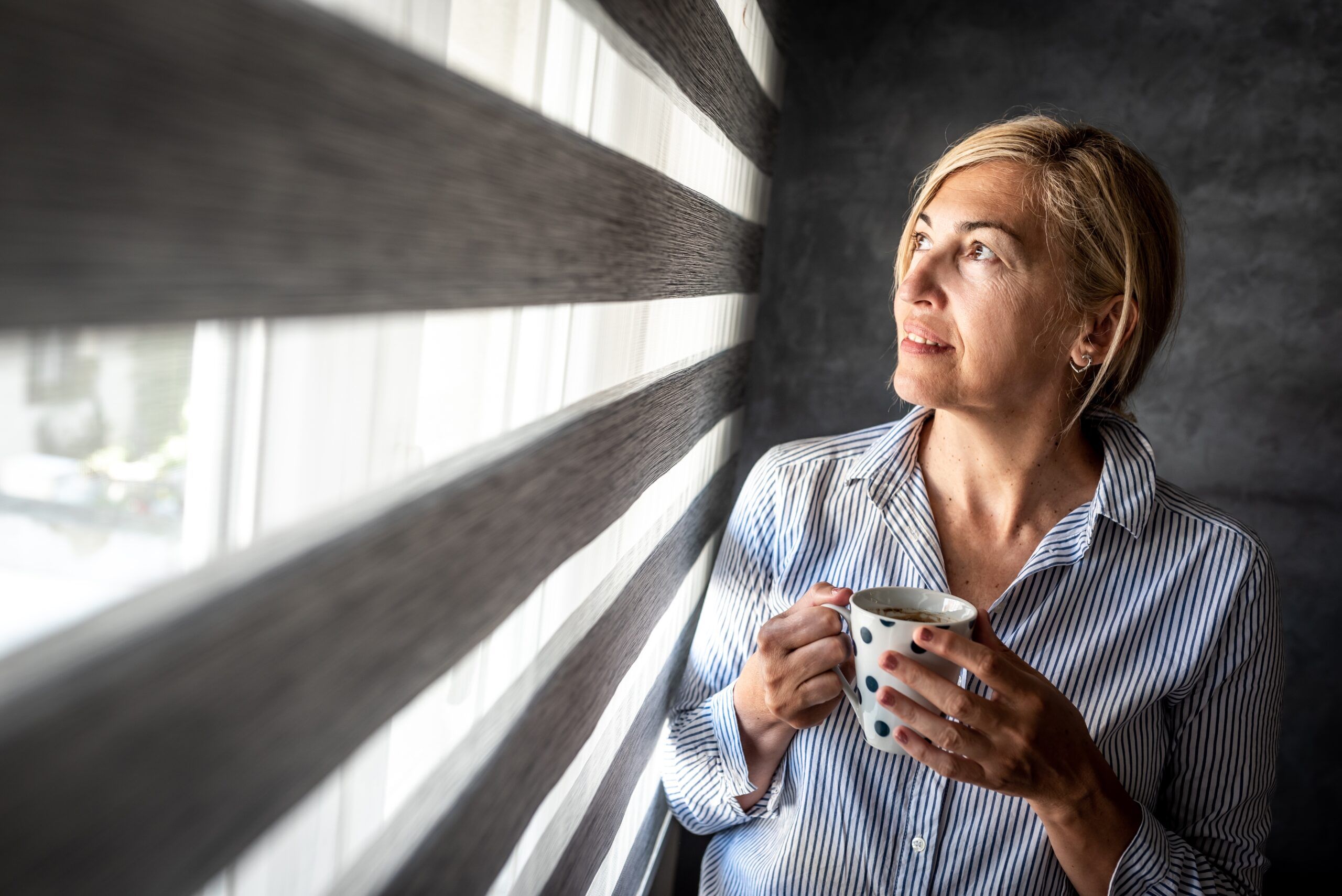 A successful midlife woman having coffee.