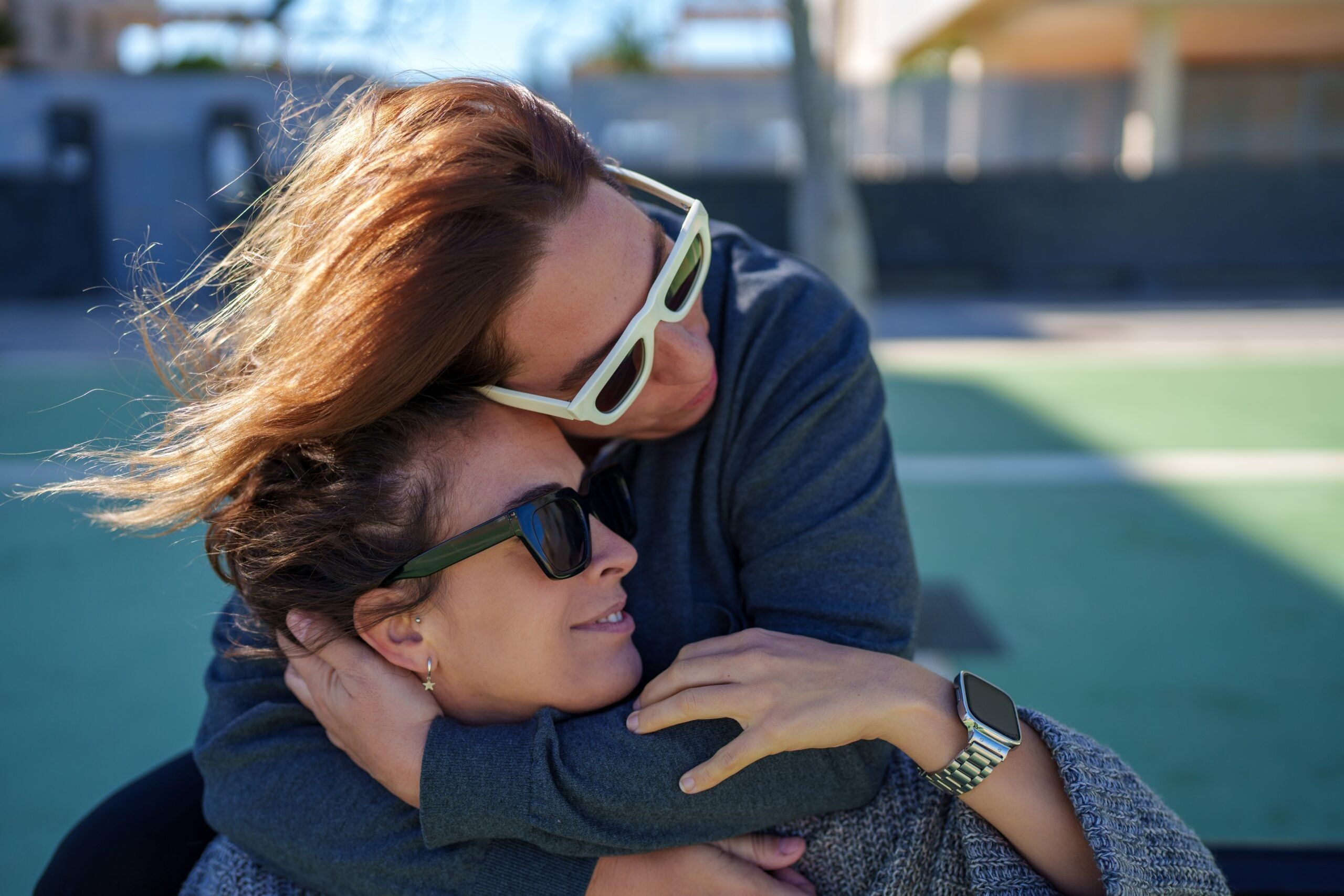 A woman supporting her friend who needs saving with a hug.