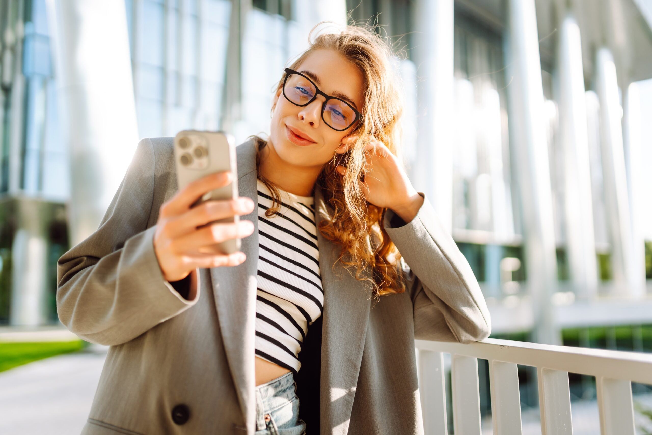 A woman deliberating how she should respond to a text to get together.