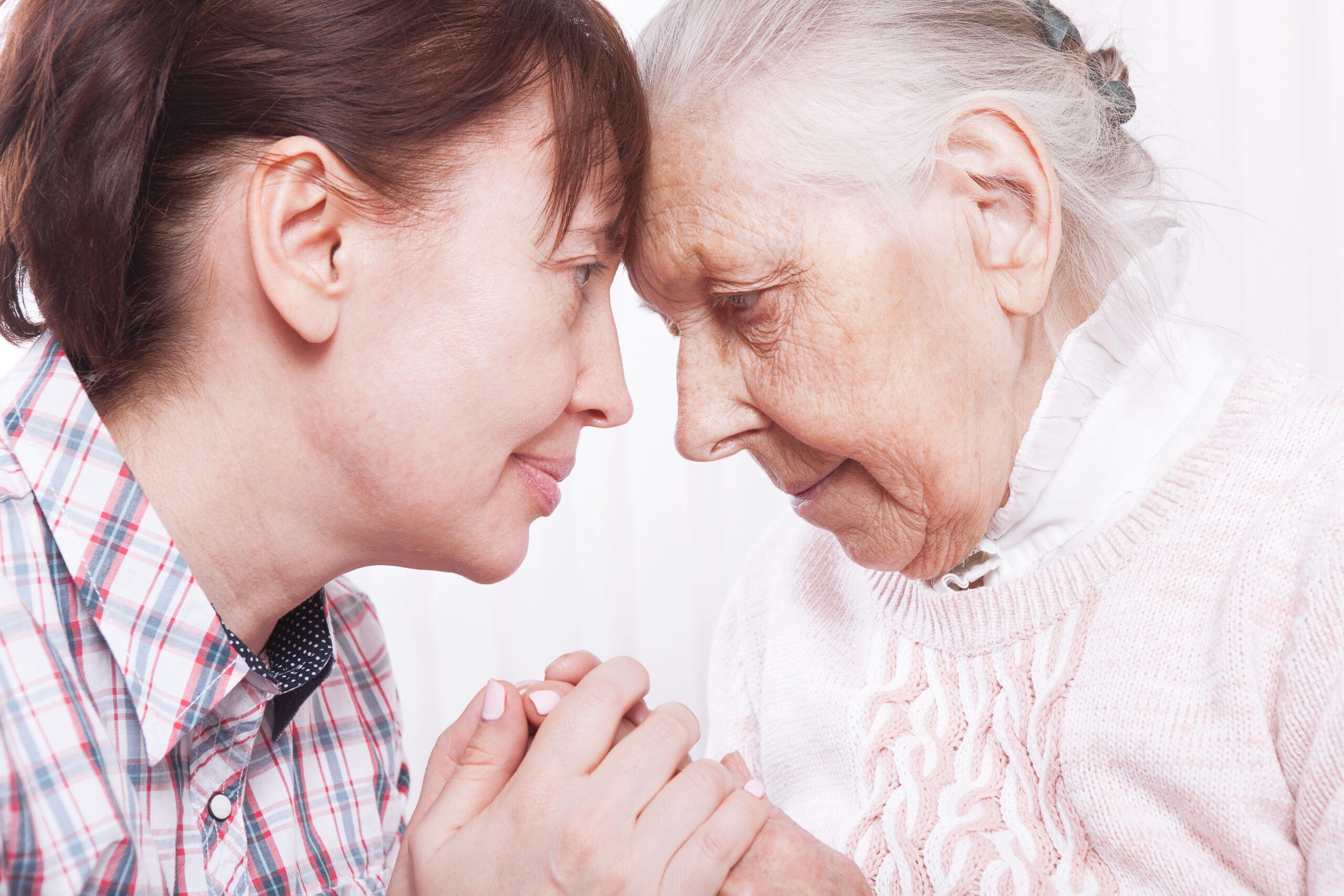 A woman in her 80s talking heart to heart with her daughter.