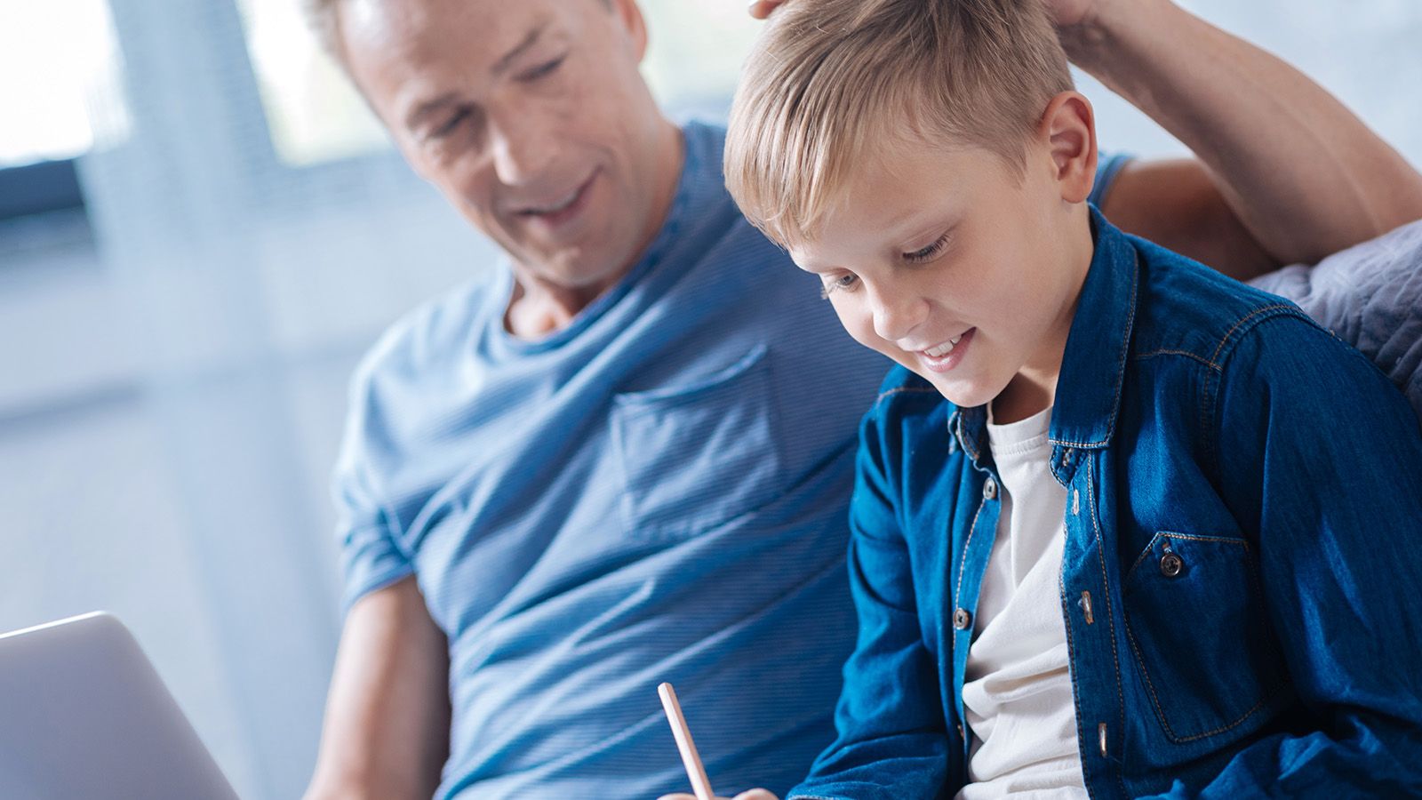 Middle-aged dad praising his son for being useful.