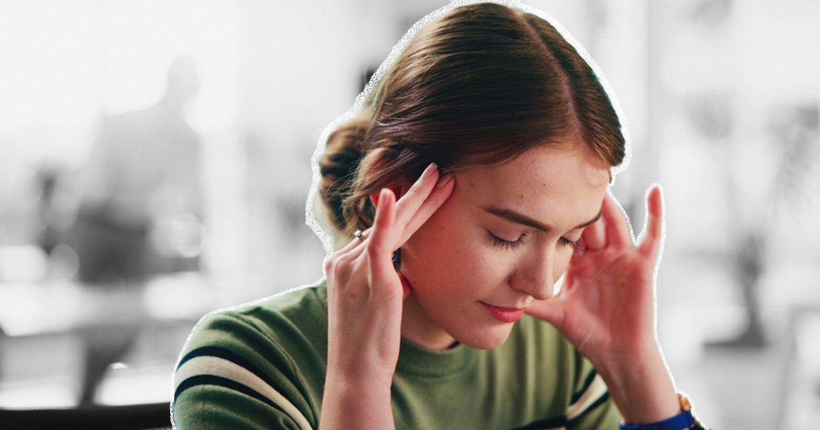 Woman with a headache reacting to bright overhead light