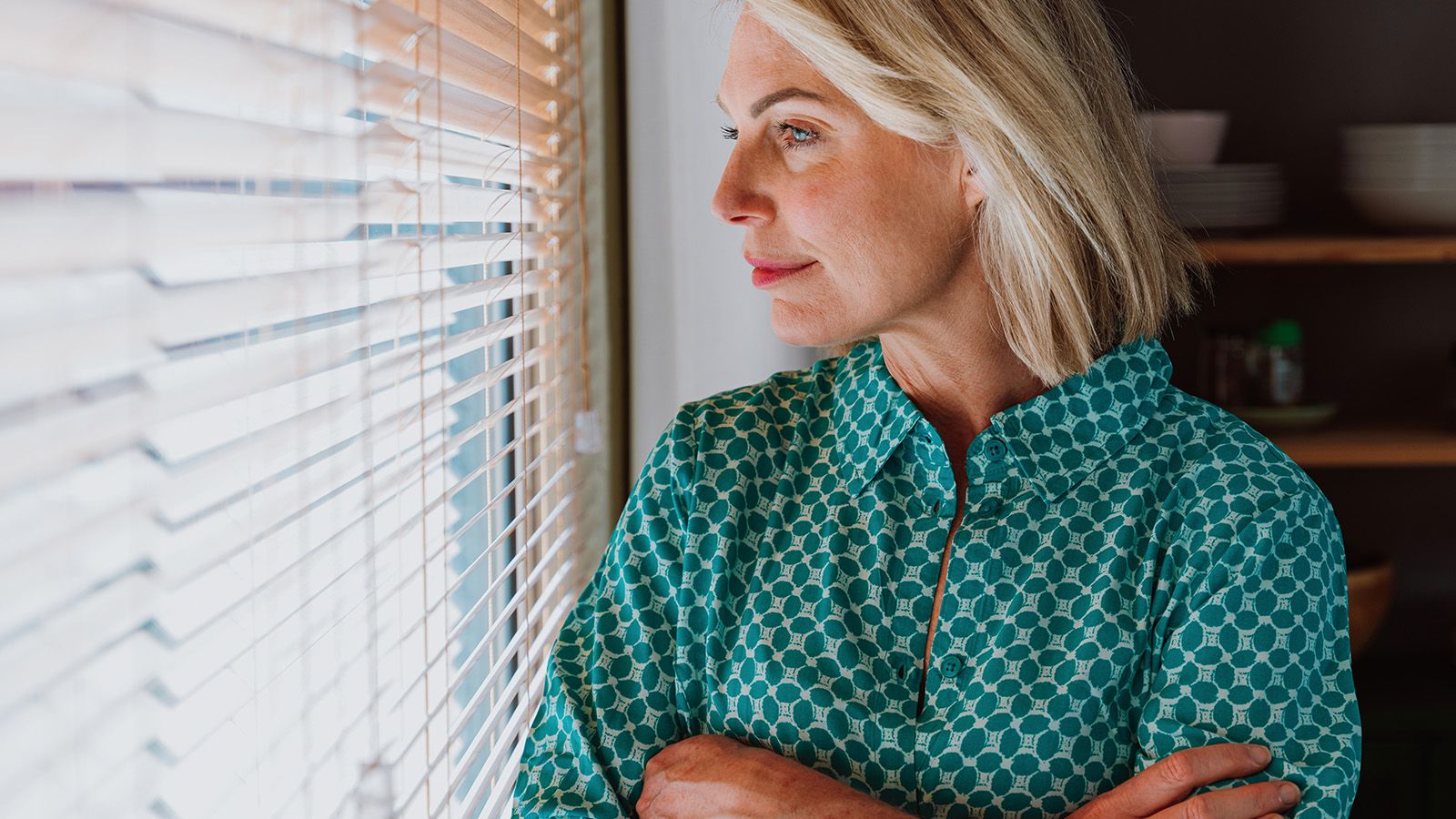Woman looking pensively out the window.