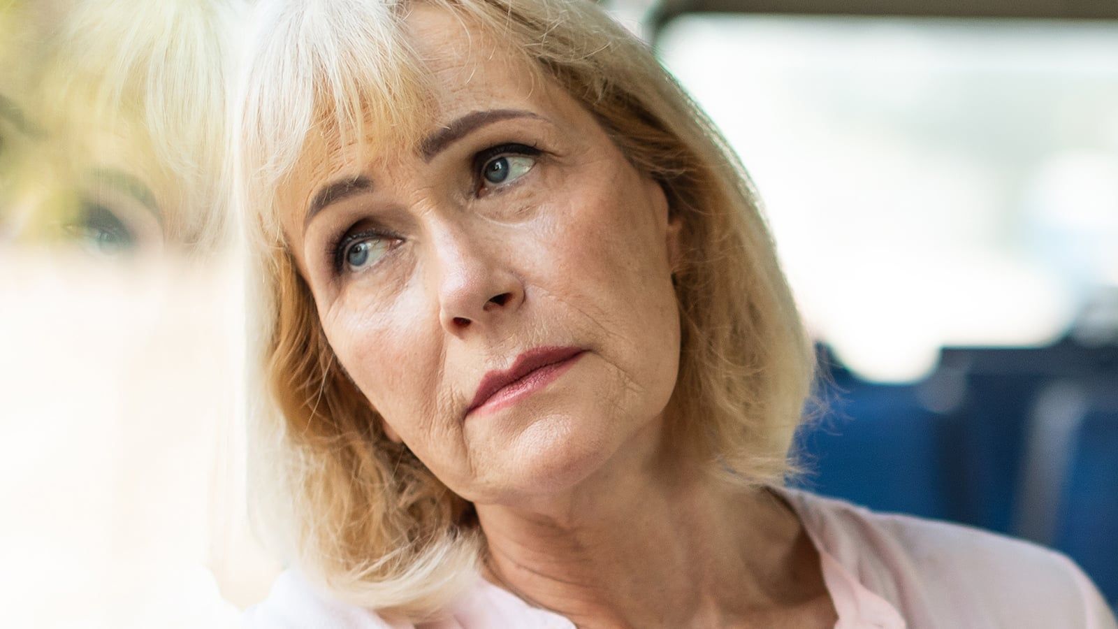 Mature woman bored looking out window