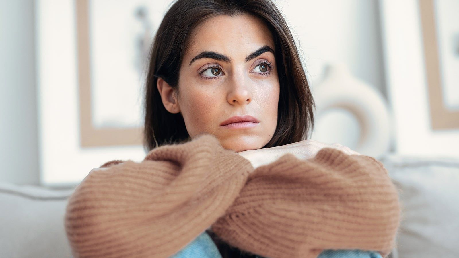 Woman feeling hollow on the inside sitting alone.