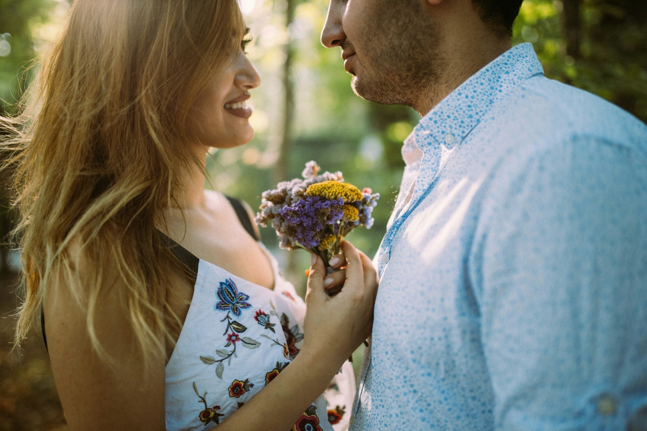 A man bringing his girlfriend flowers during the first month of their relationship.
