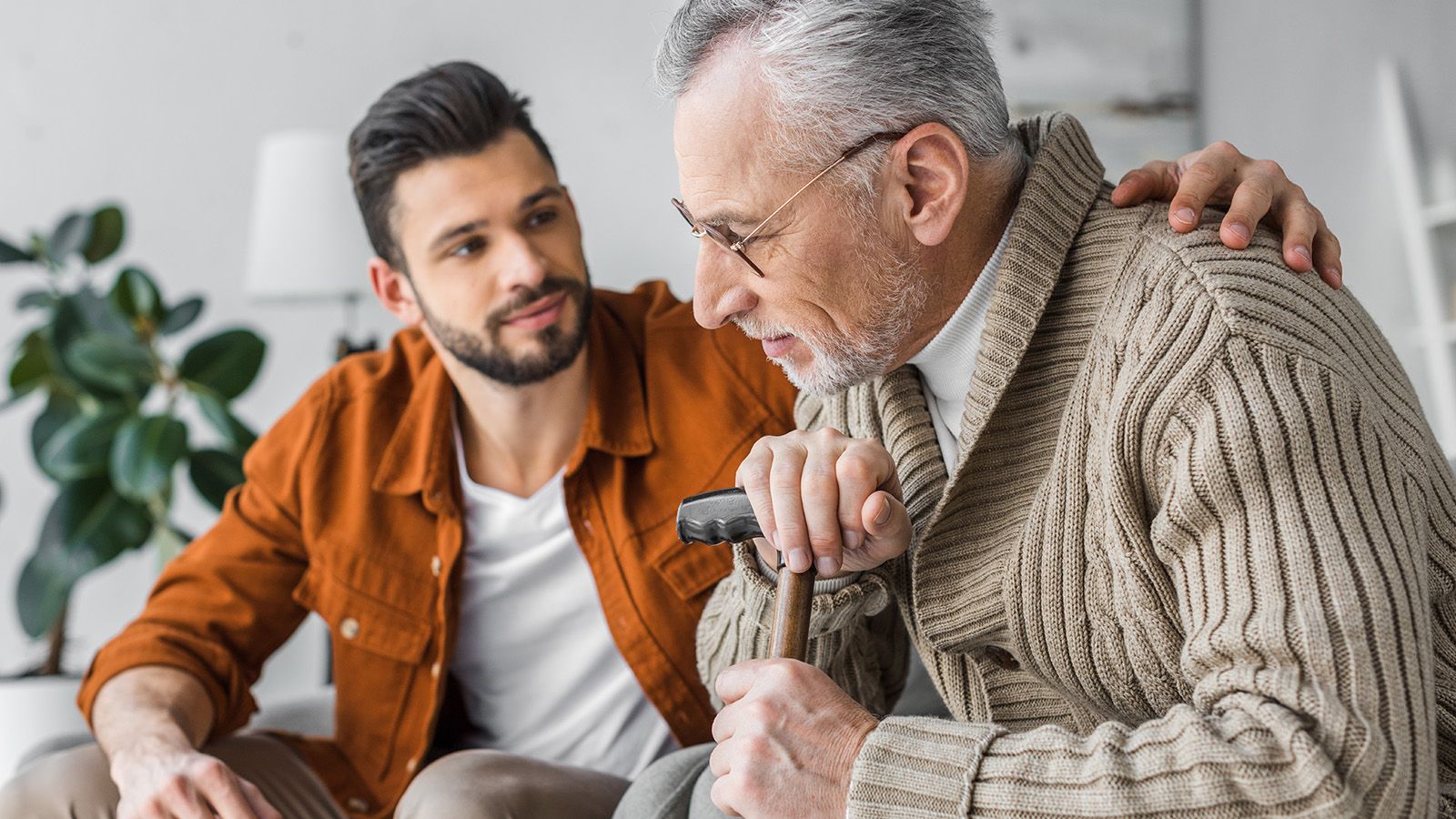 Man with his aging father having a conversation where his father seems lonely.