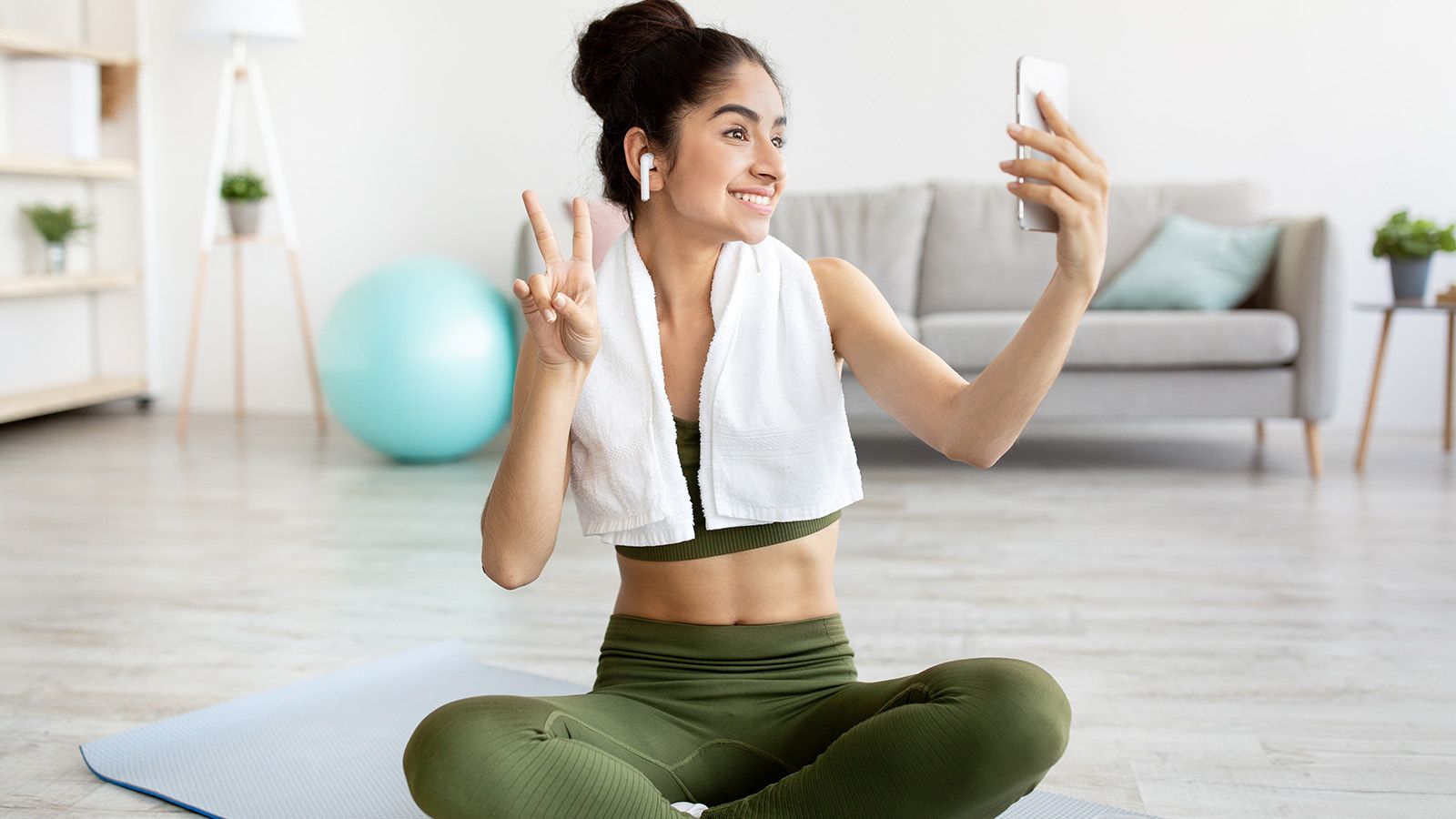 Woman taking selfie to post to social media, unlike many millennials who opt out of constantly sharing their lives with the world.