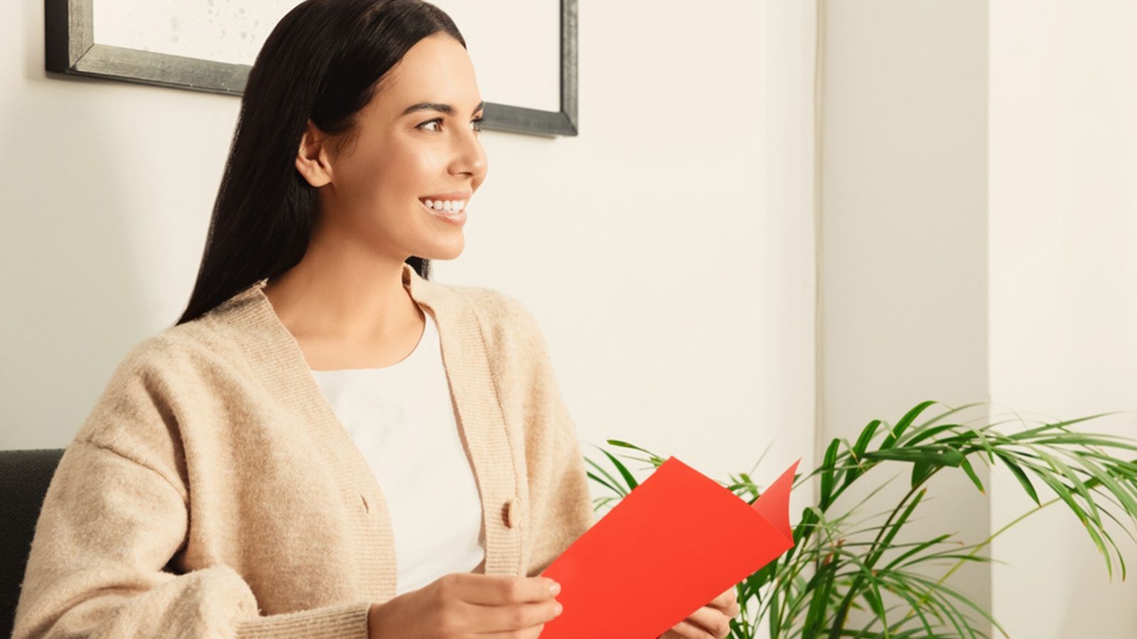 Woman getting birthday card in the mail and feeling good about it.