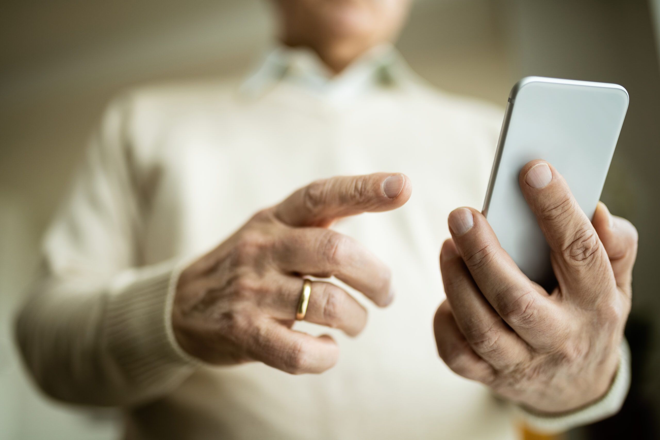 A senior man on the phone with his adult son for the first time in two months.