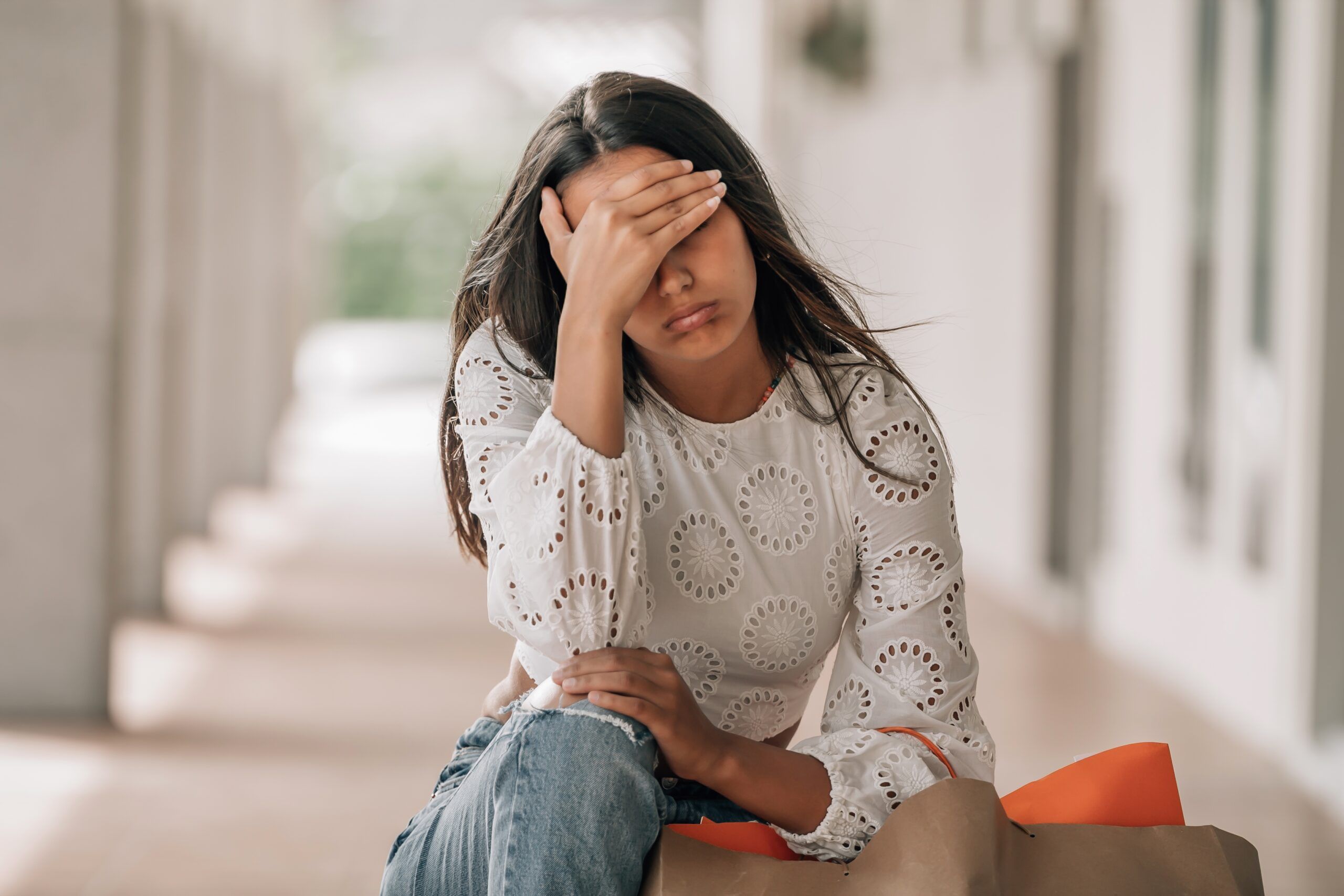 A woman feeling burnout from mental clutter.