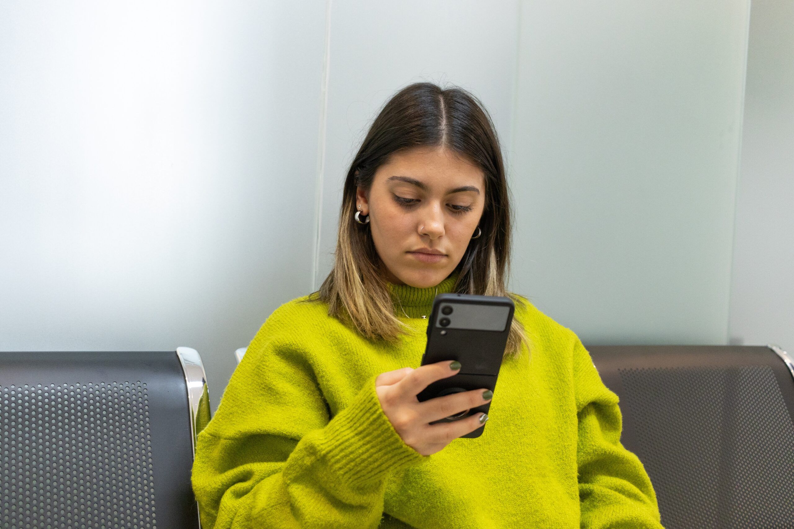 Distant young woman texting her friend to make plans.