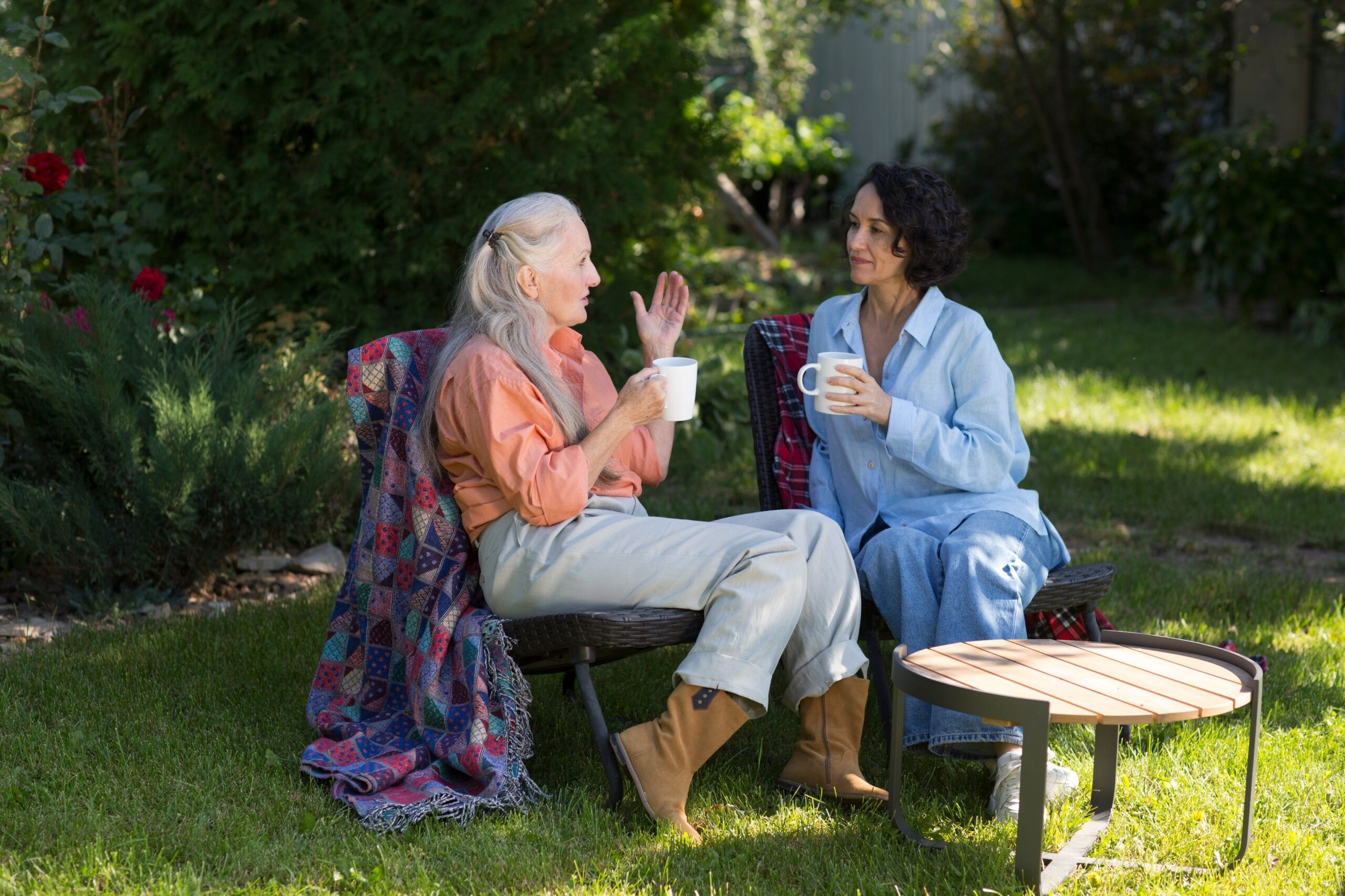 A woman with high emotional intelligence speaking with her friend in the garden.