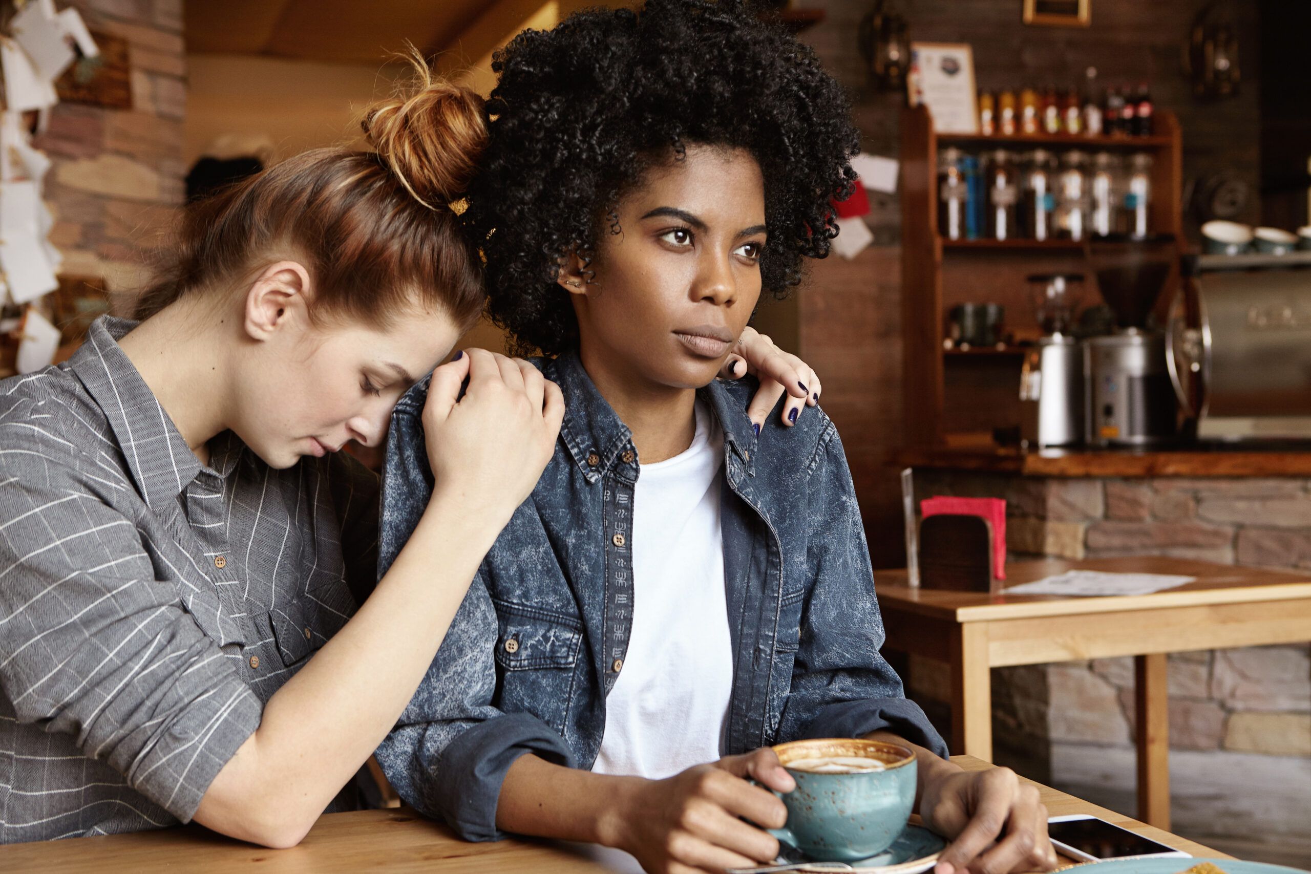 A woman apologizing quickly to her friend.