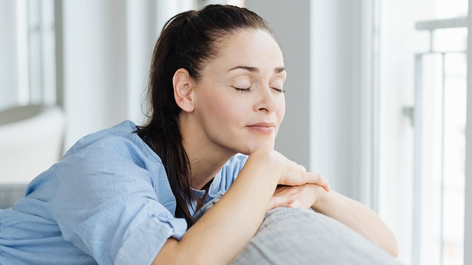 Serene woman closing her eyes and at peace