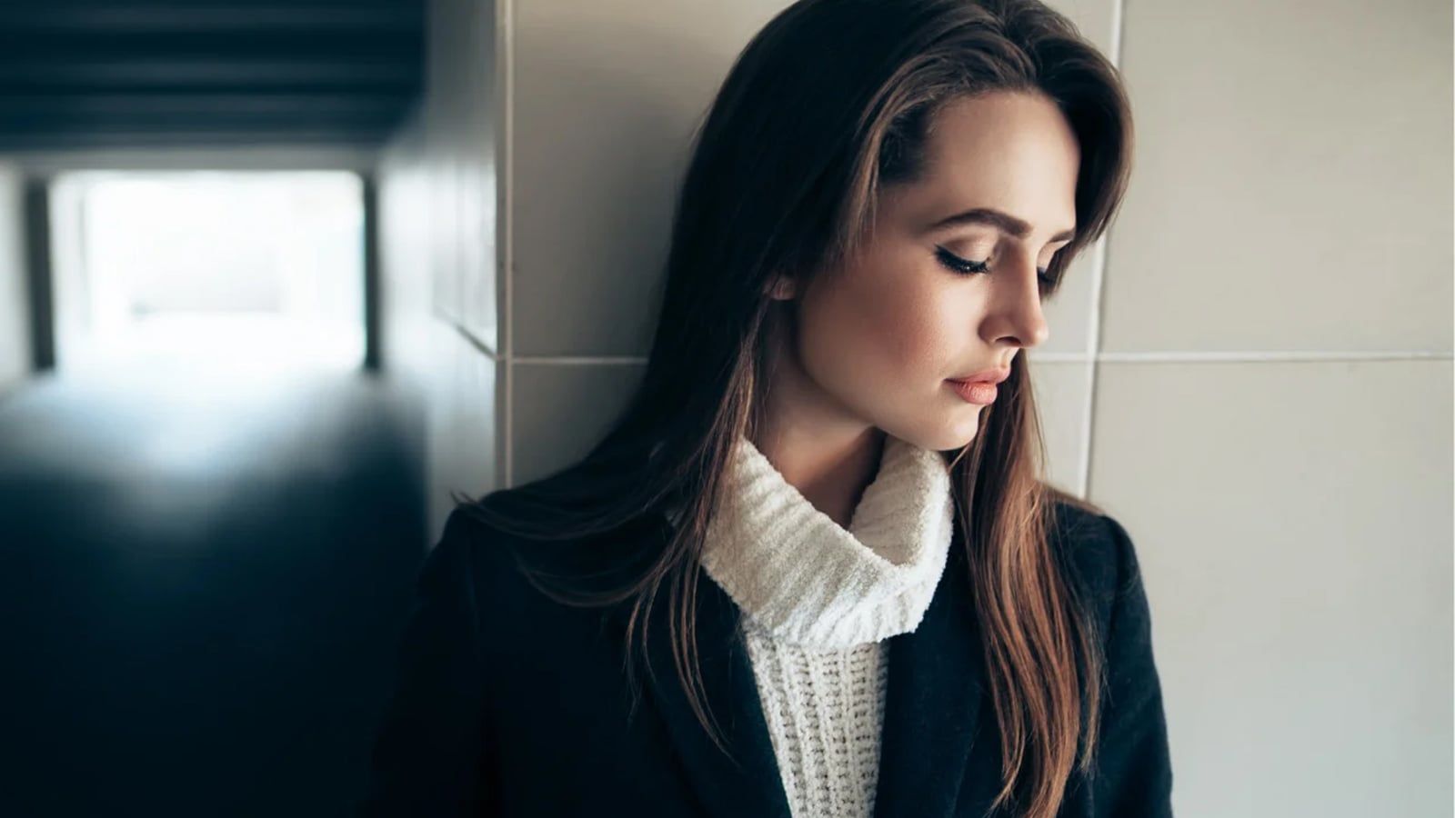 Beautiful lonely woman in a subway tunnel.