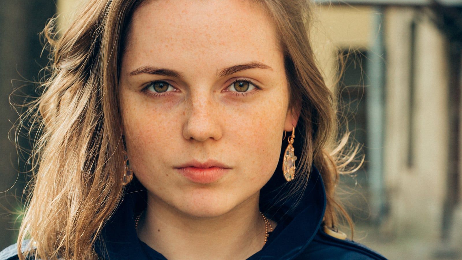 Beautiful woman face portrait freckles serious expression