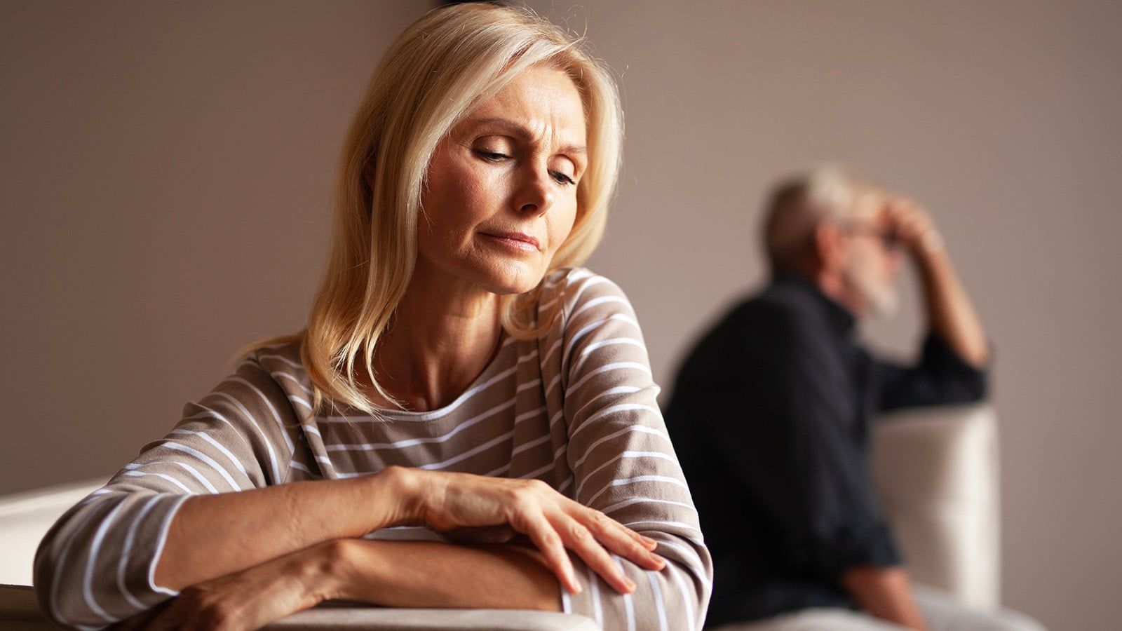 The older couple has a conflict. Upset mature woman, quarrel with her husband. Relationship crisis.