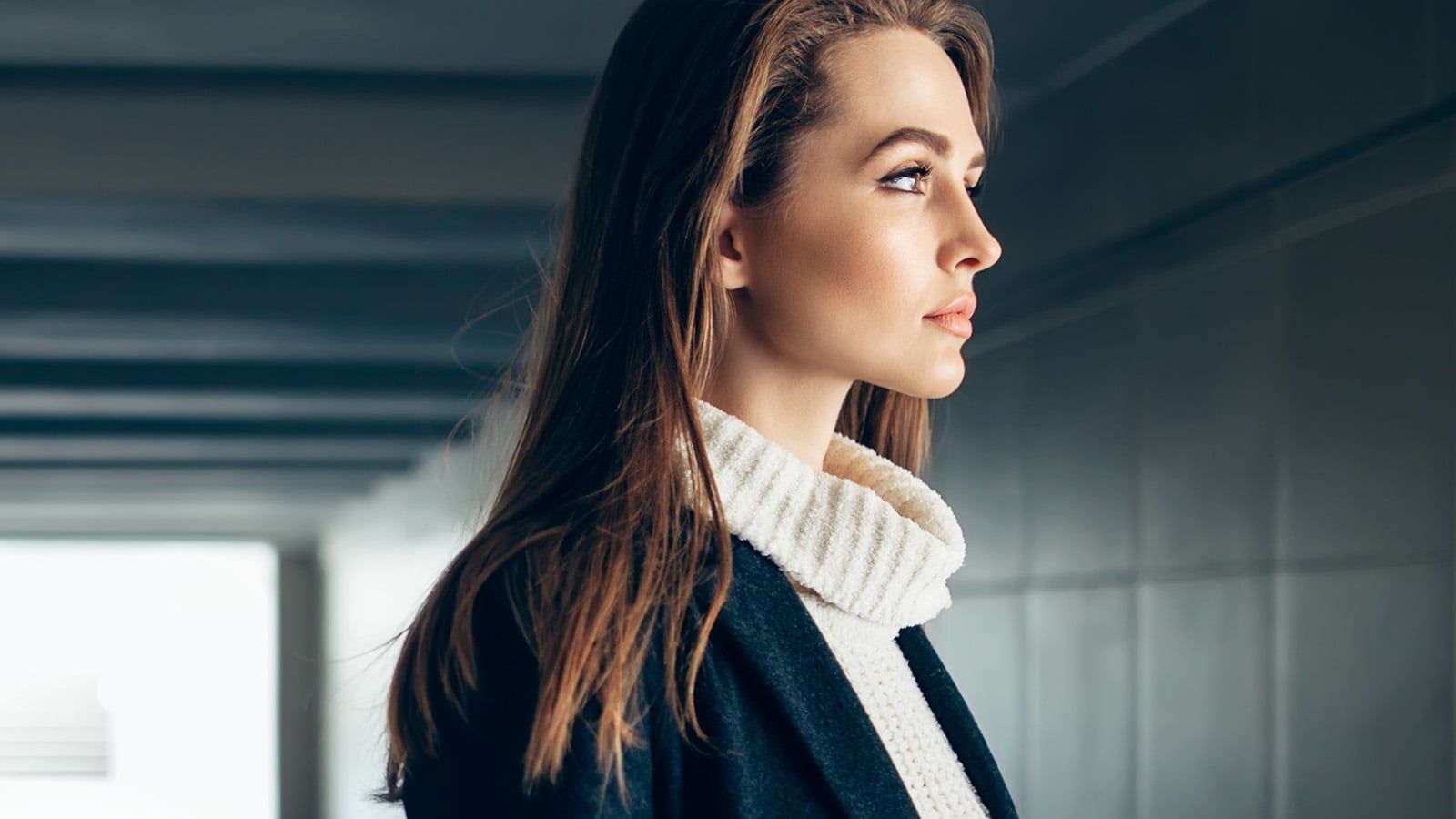 Beautiful lonely woman in a subway tunnel.