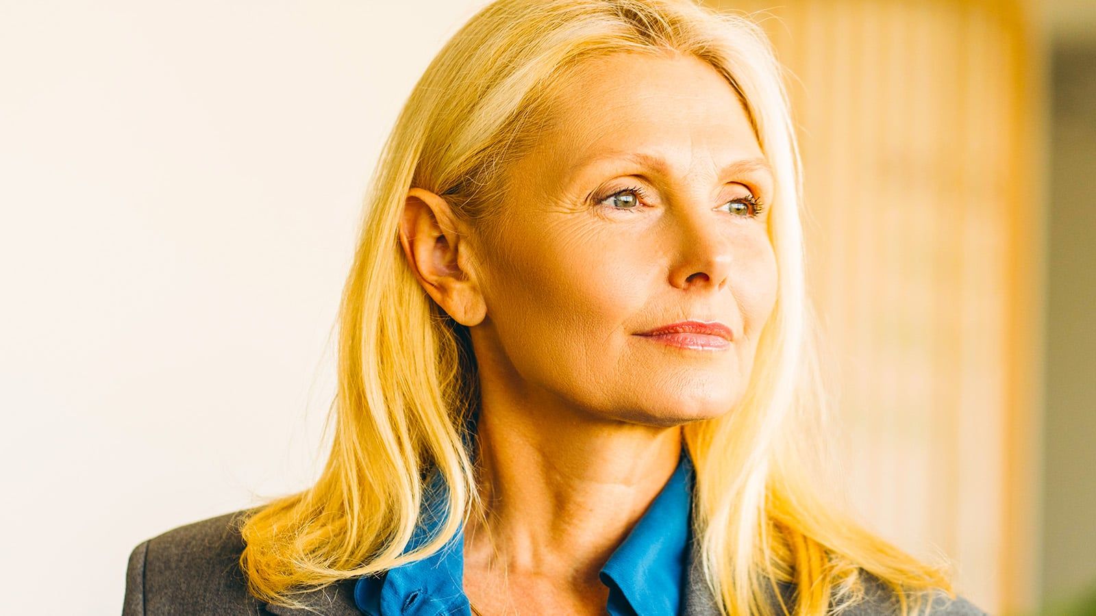 Beautiful older businesswoman staring intently out the windoe
