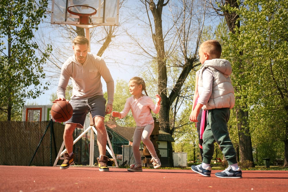 A happy family playing basketball together