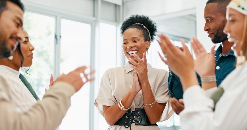 A group of business people at work, clapping