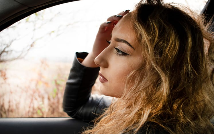 woman with long blonde hair in a car