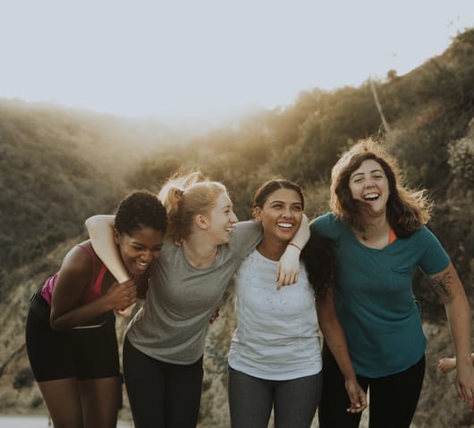 four women smiling together