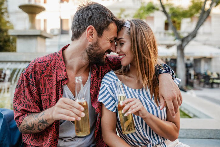 couple having beer outside cafe