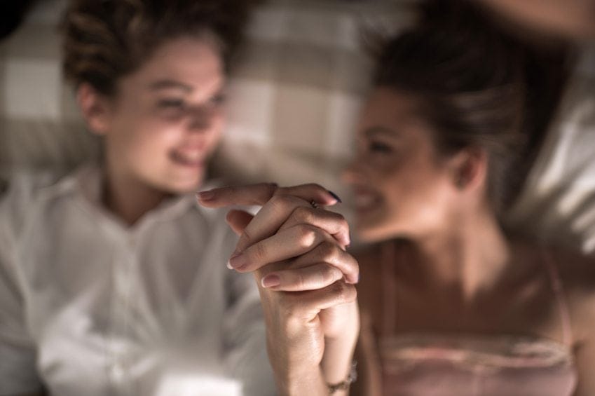 two women holding hands