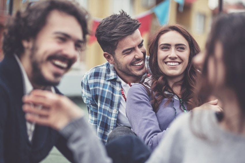 woman with guy friends laughing